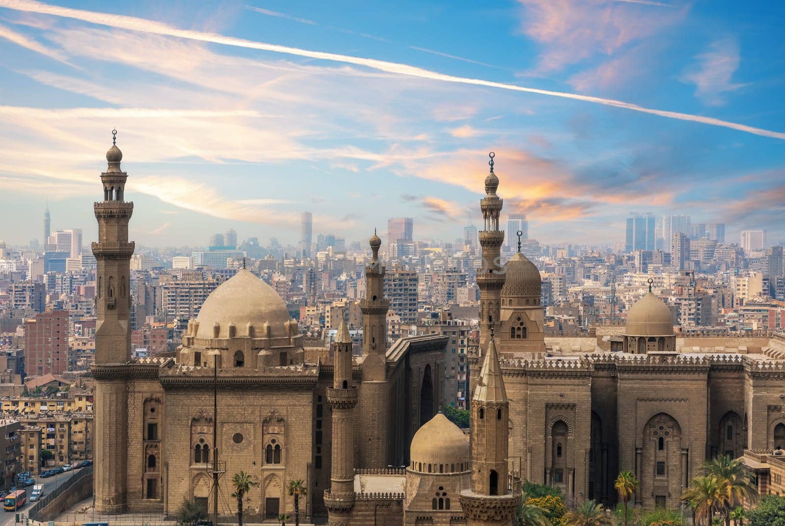 The Mosque-Madrassa of Sultan Hassan at sunset and the city view, Cairo, Egypt.