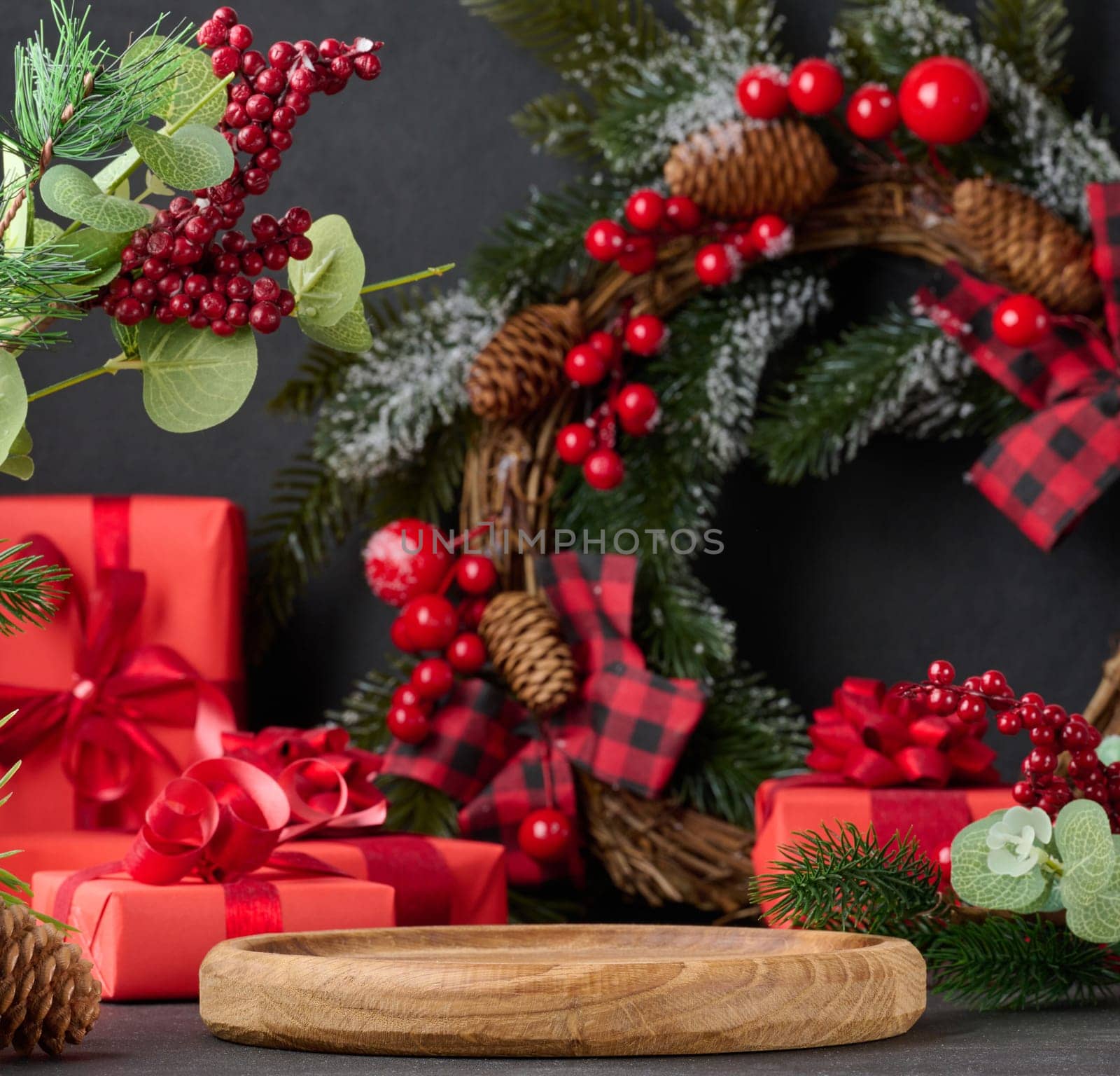 Empty round wooden platform for displaying products in the middle of Christmas decor