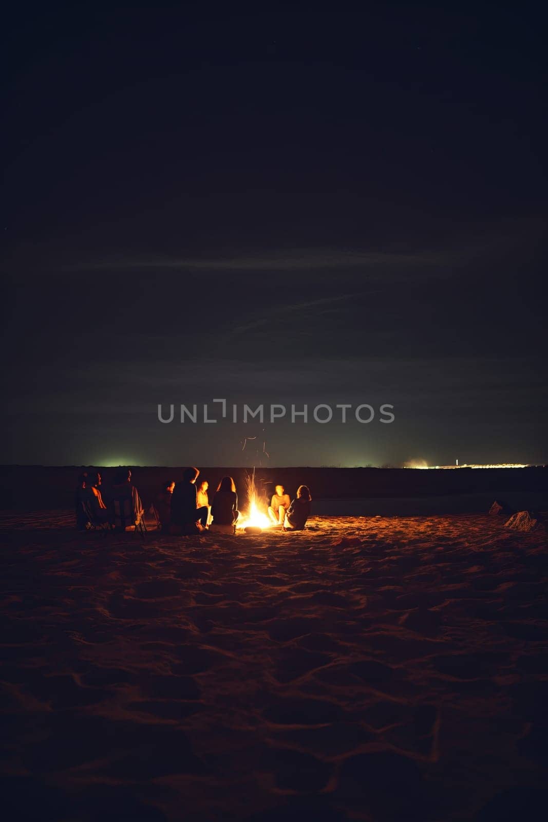 Inviting campfire on the beach during the summer, bring back fond memories. Fun and good times at the lake or sea.