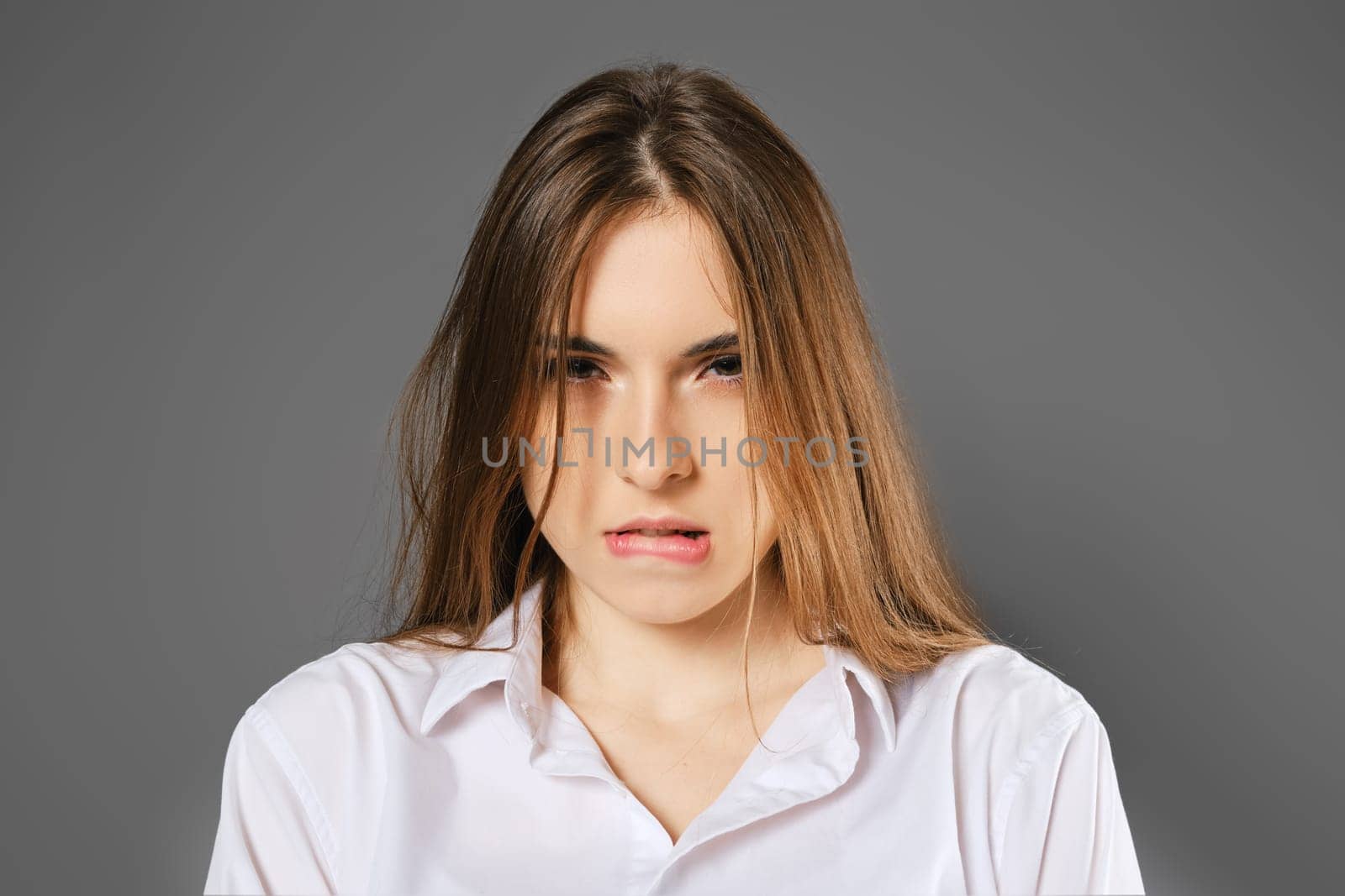 Closeup portrait of a woman who made a mistake and bit her lip