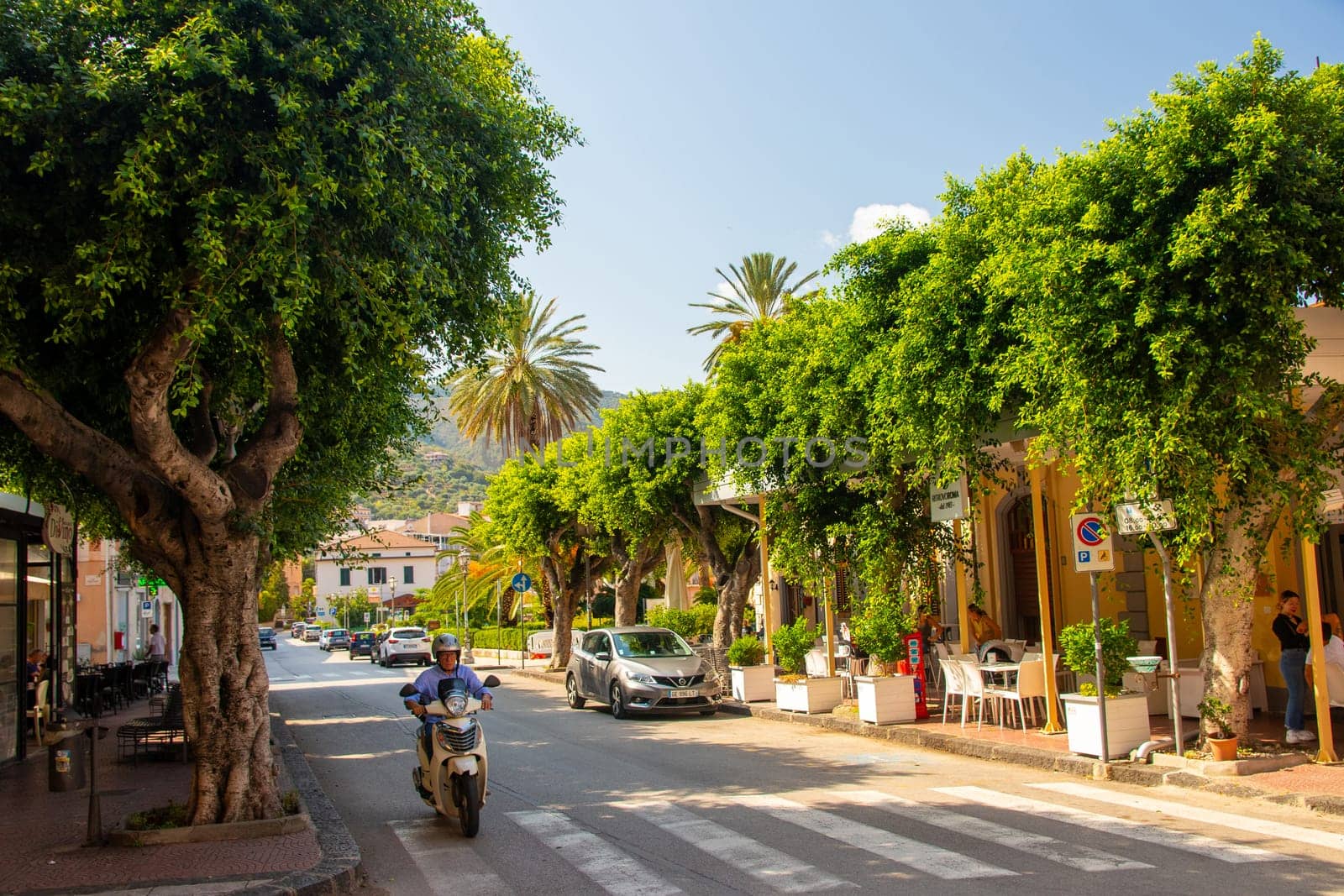 Gioiosa Marea, Sicily, Italy - 27. September 2023. Centre of the town of Gioiosa Marea with a street cafe and an ice cream bar in the province of Messina.