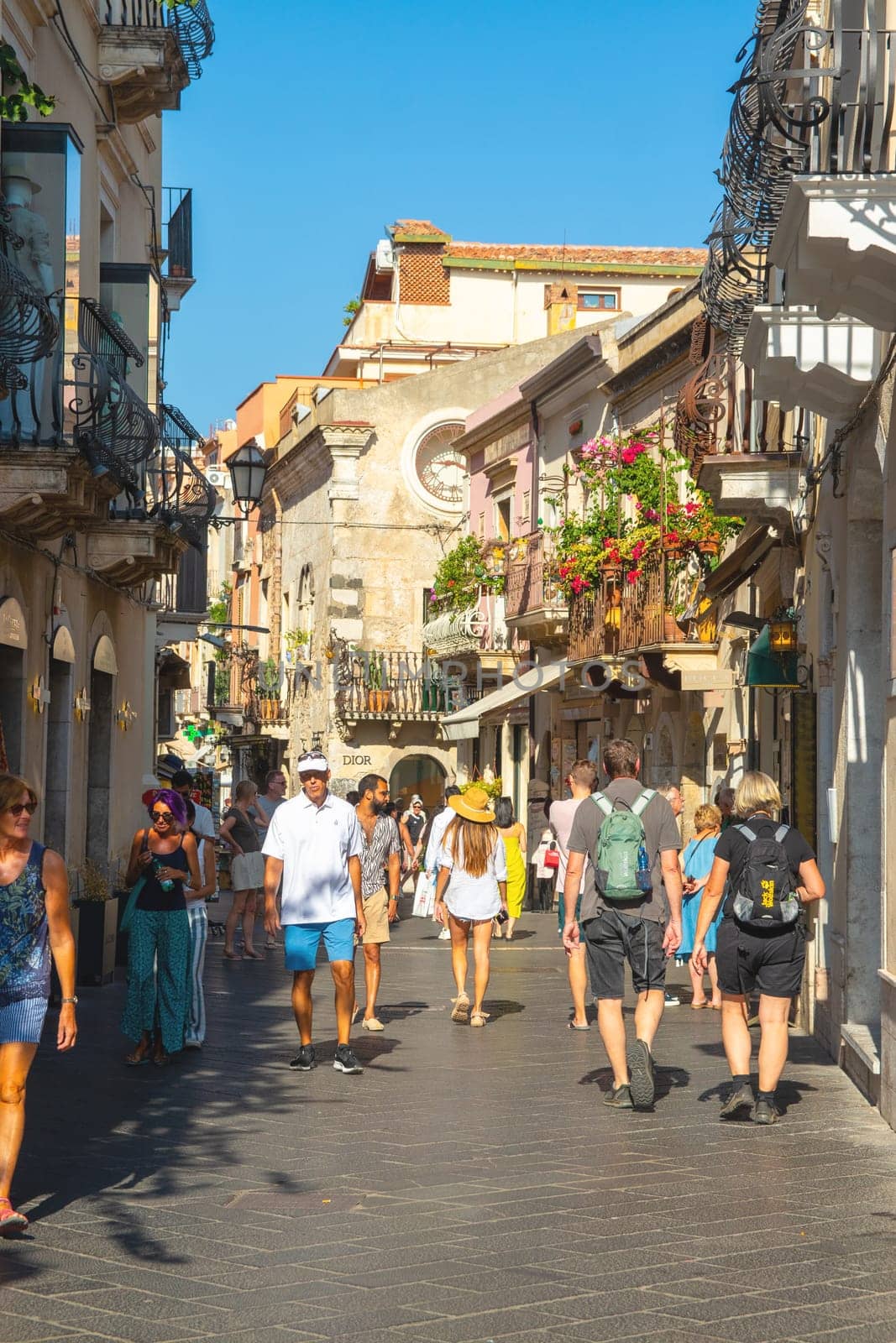 Taormina, Sicily, Italy - 28 September 2023. Tourists in the famous main street Corso umberto in Taormina. City views, facades, architecture and the most popular streets.
