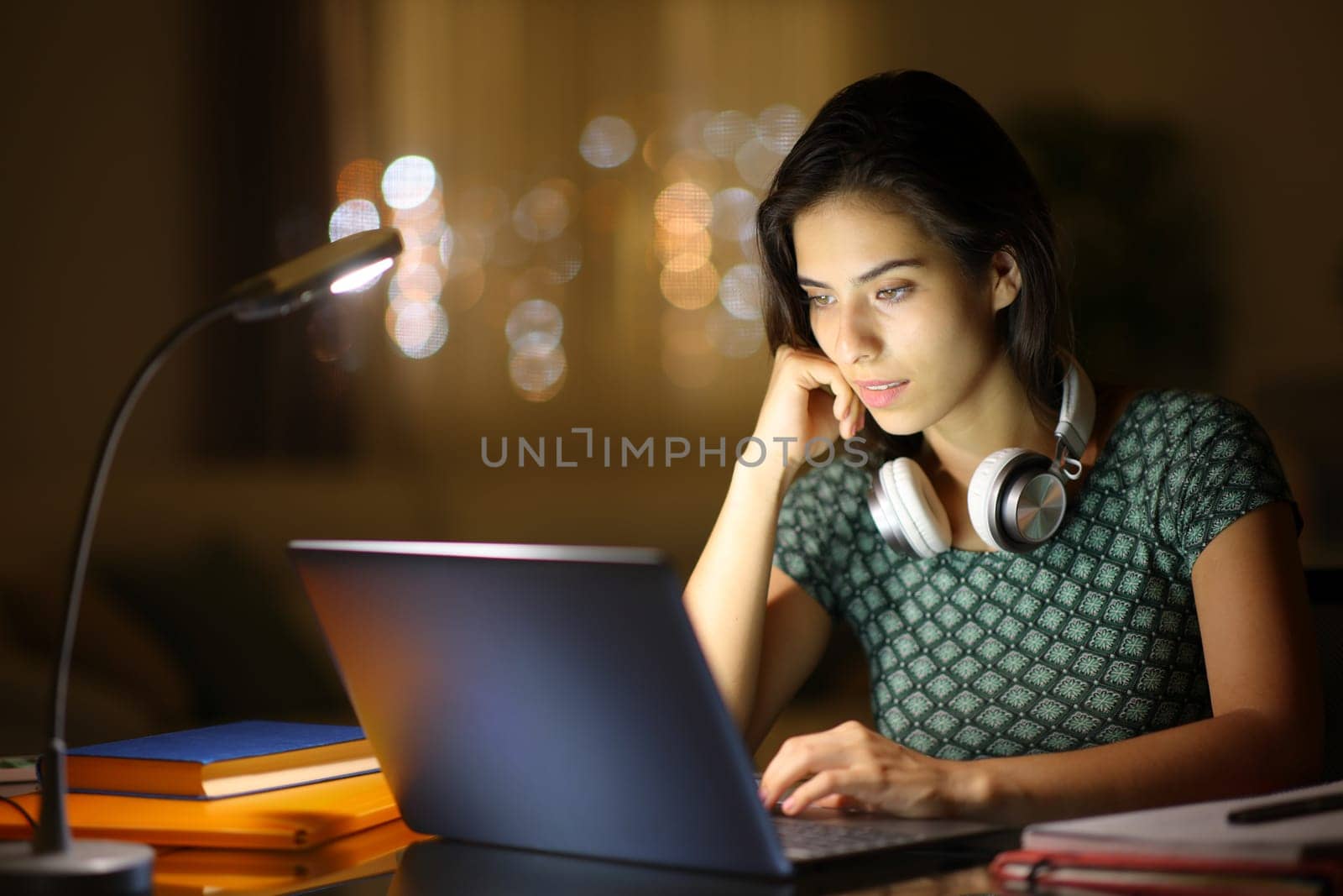 Student in the night e-learning using laptop at home