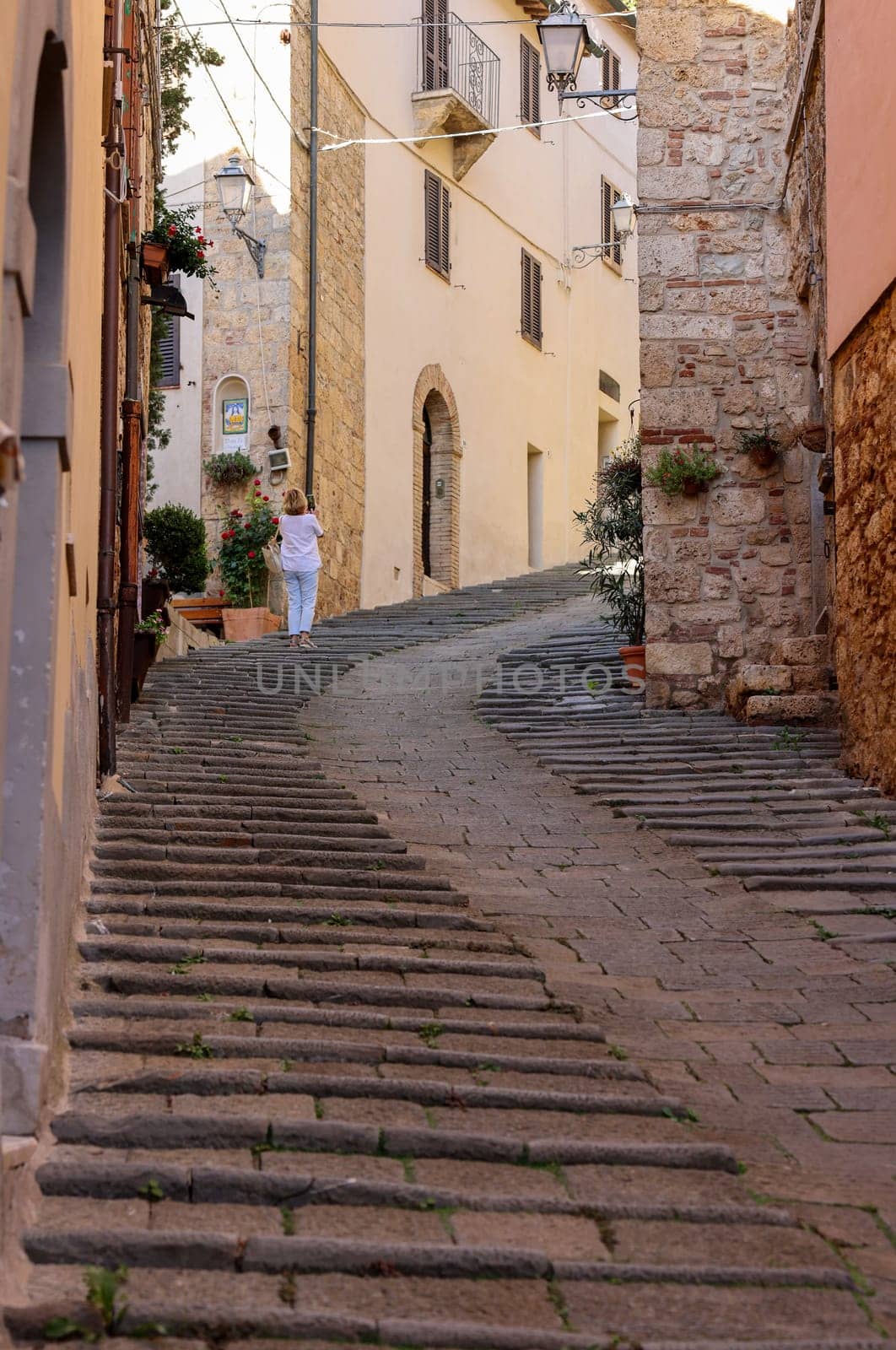 Massa Marittima, Italy - Sept 11, 2022: Steep and narrow street in old town of Massa Marittima, Italy