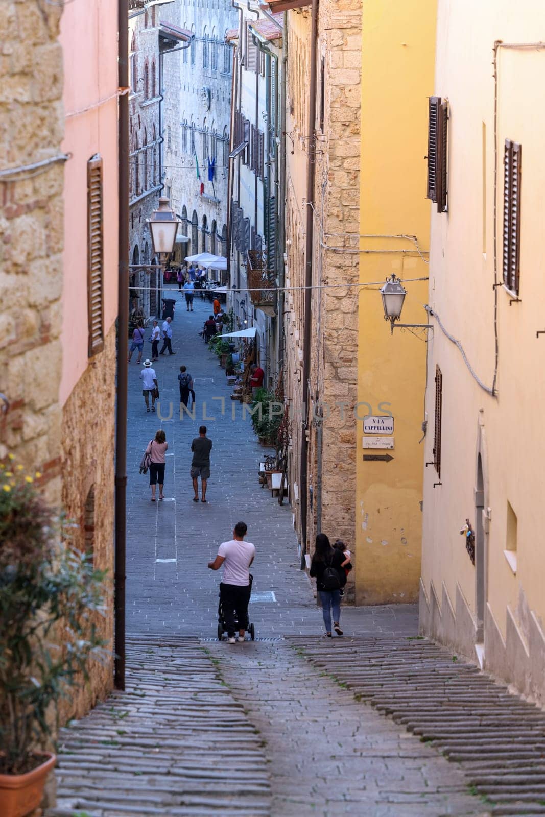 Massa Marittima, Italy - Sept 11, 2022: Steep and narrow street in old town of Massa Marittima, Italy