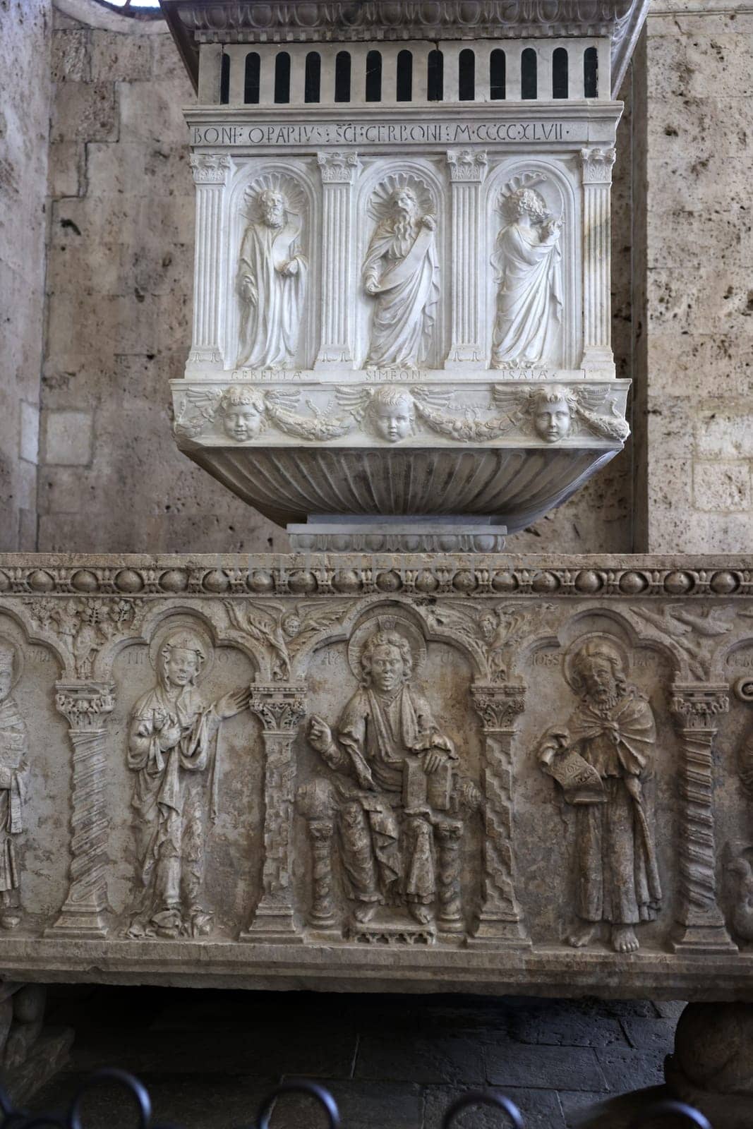 Massa Marittima, Italy - Sept 11, 2022:  Monumental baptismal font, with a rectangular bath surmounted by a small temple. The baptistery dates from 1267. Cathedral of Saint Cerbonius in Massa Marittima. Italy