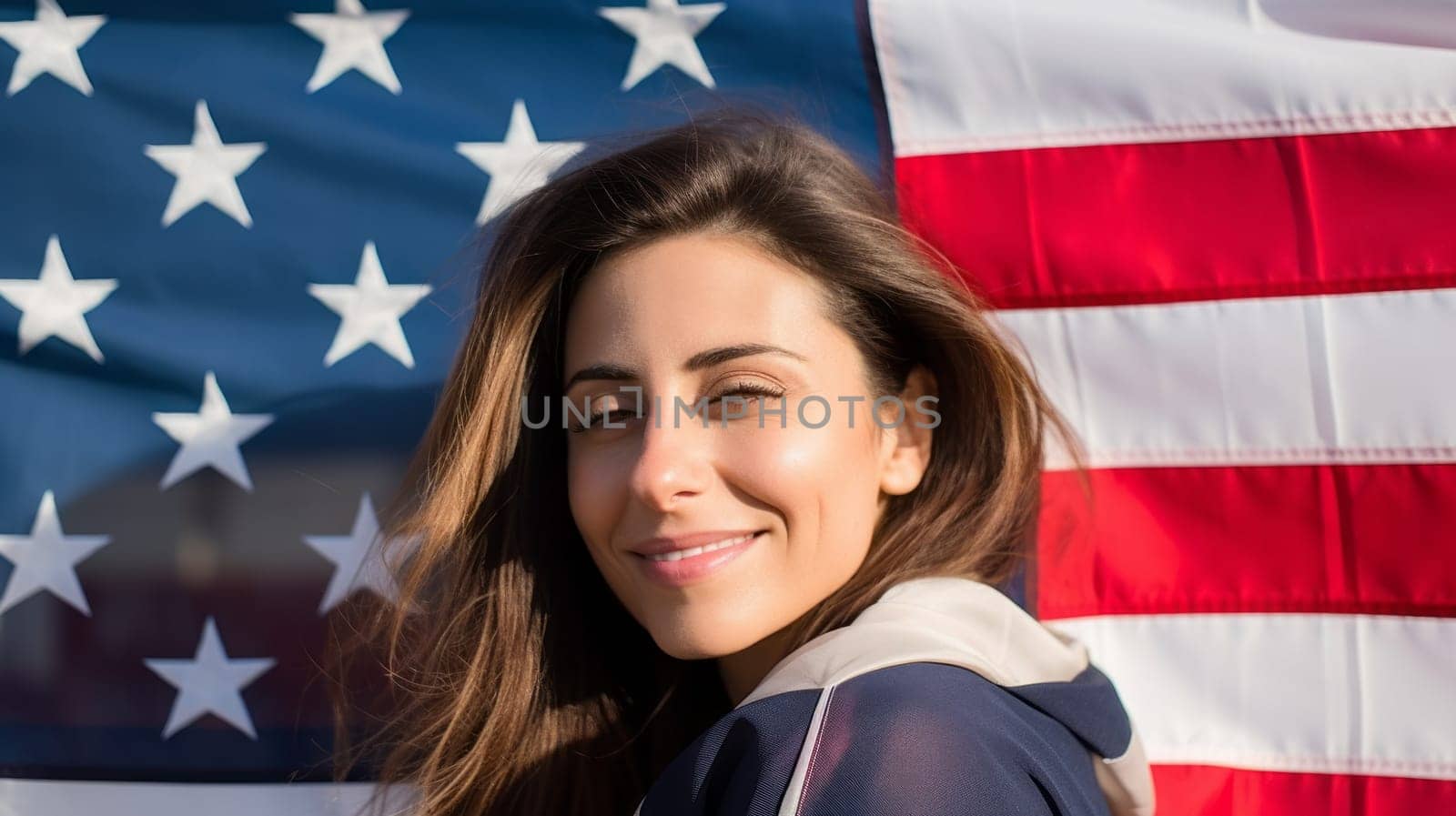 Young brunette woman with United States USA flag behind her.