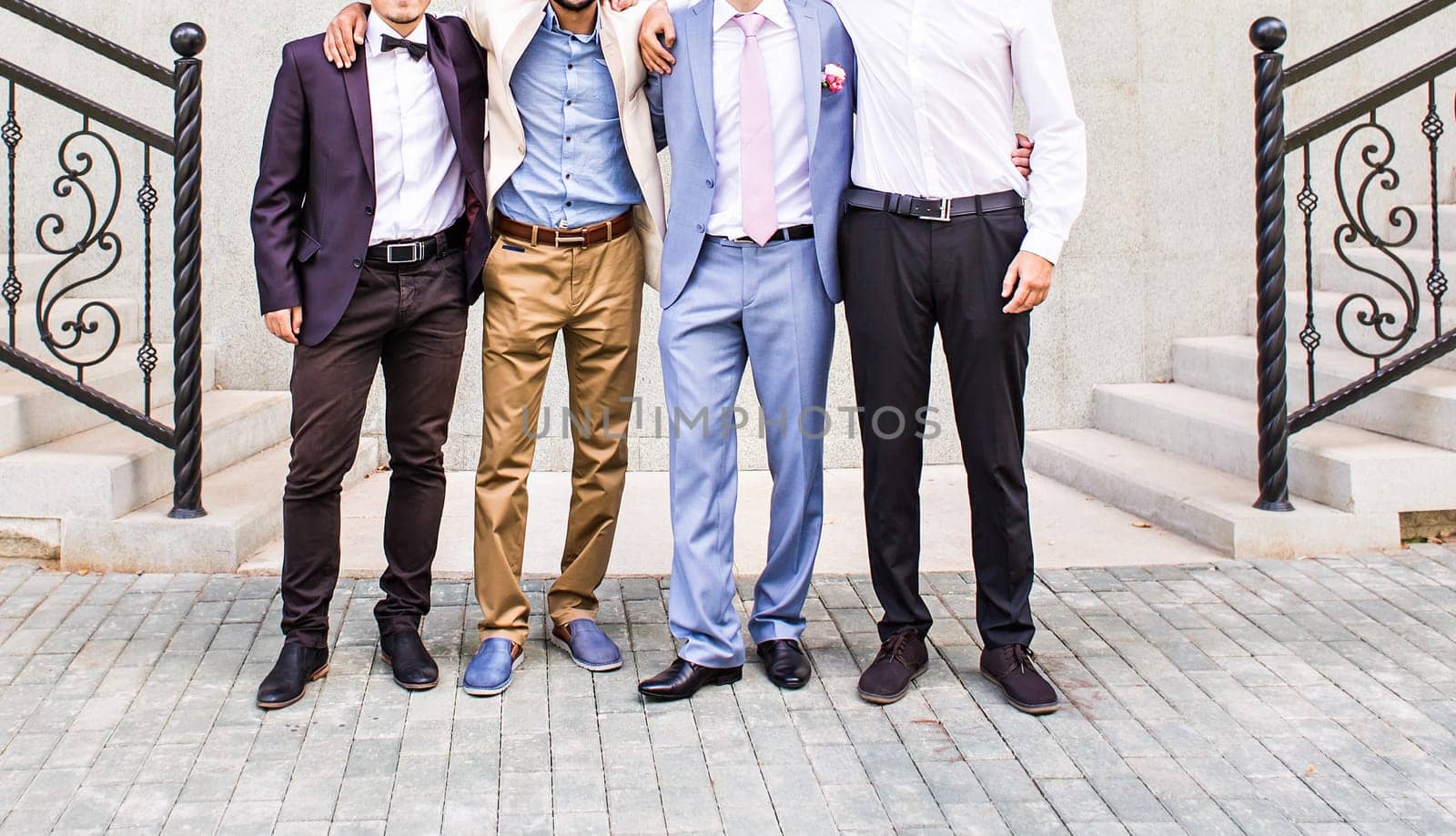 Groom With Best Man And Groomsmen At Wedding.