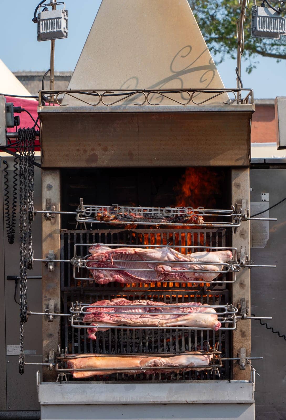 the suckling pig on the rotisserie on the open fire