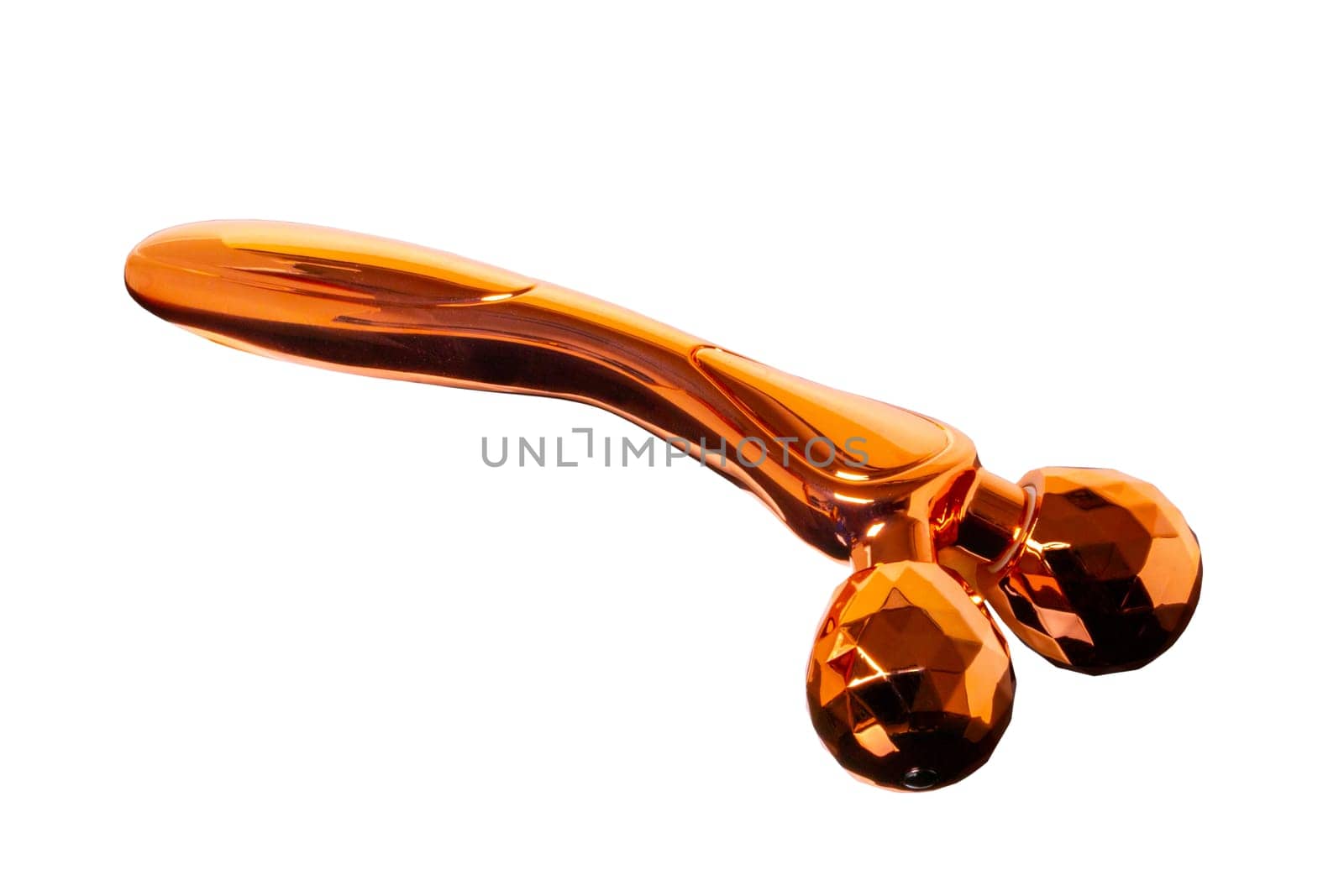 Skin care tools. Close-up of a golden metal 3D face massager, face lift roller for better blood circulation and muscle activation isolated. Clipping path. Beauty, skin treatment concept.