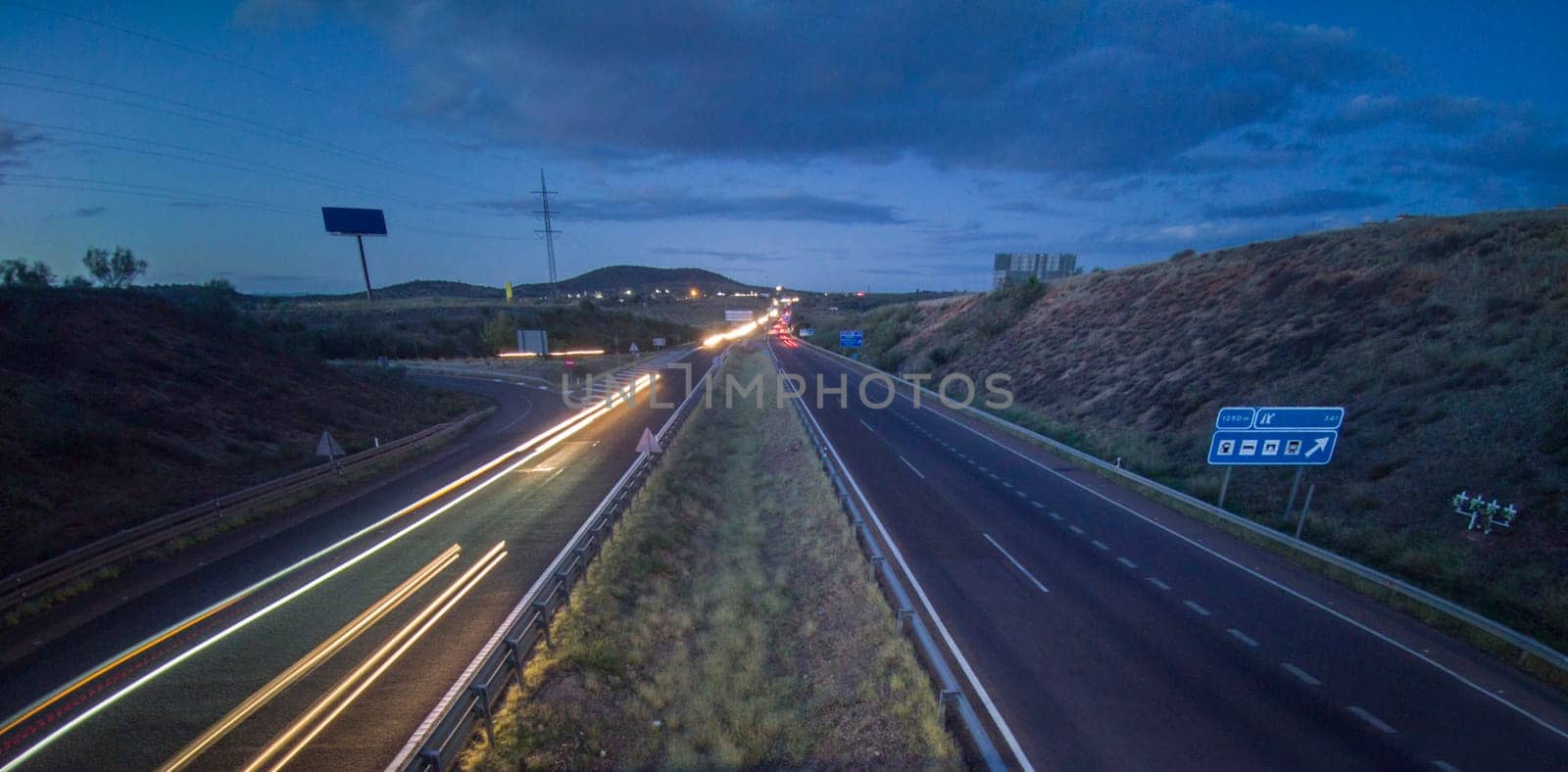 Traffic at dusk crossing the Autovia A-5, km 341. Slow motion shot