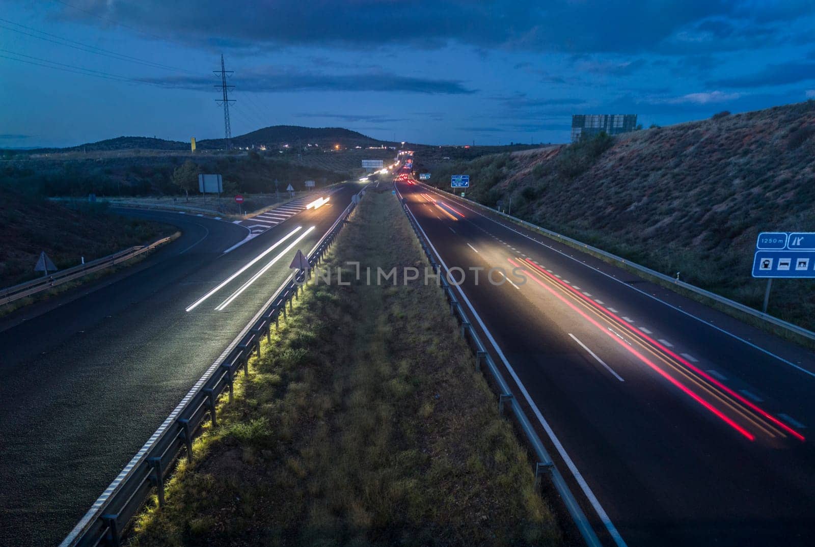 Traffic at dusk crossing the Autovia A-5, km 341. Slow motion shot