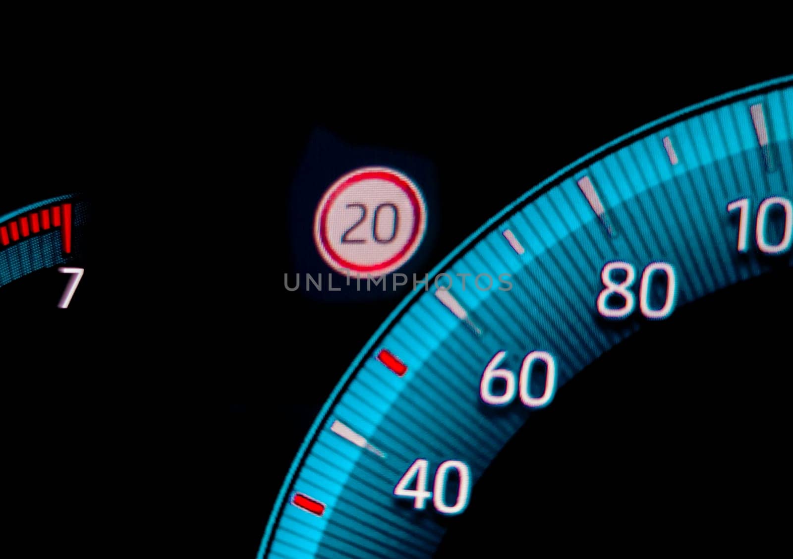 Speed limit warning close to speedometer indicator. Digital car dashboard closeup