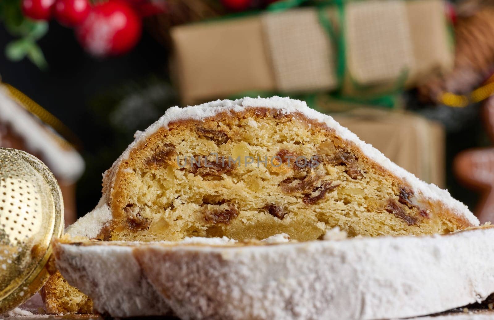 Christmas pastries stollen sprinkled with powdered sugar on the table, festive dessert