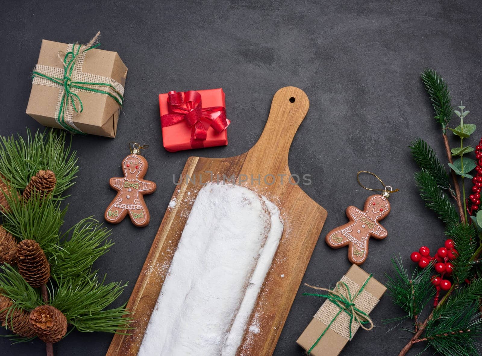 Christmas pastries stollen sprinkled with powdered sugar on the table, festive dessert