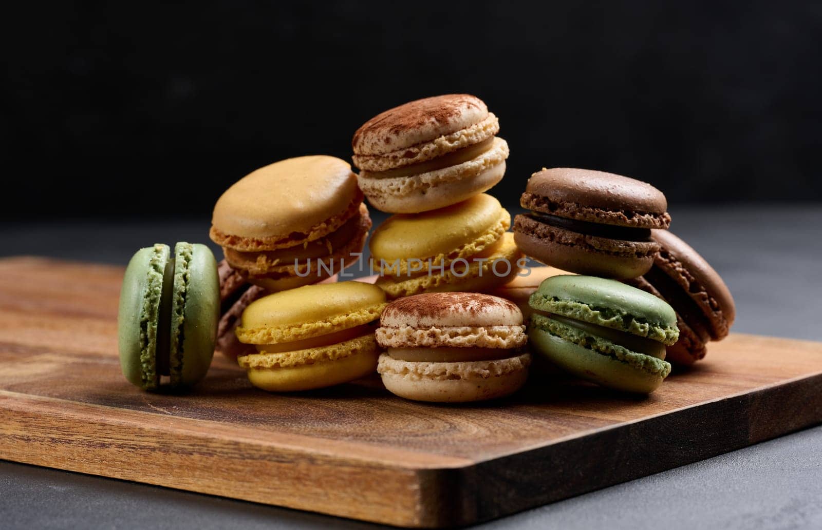 Assortment of colorful macarons on a black background