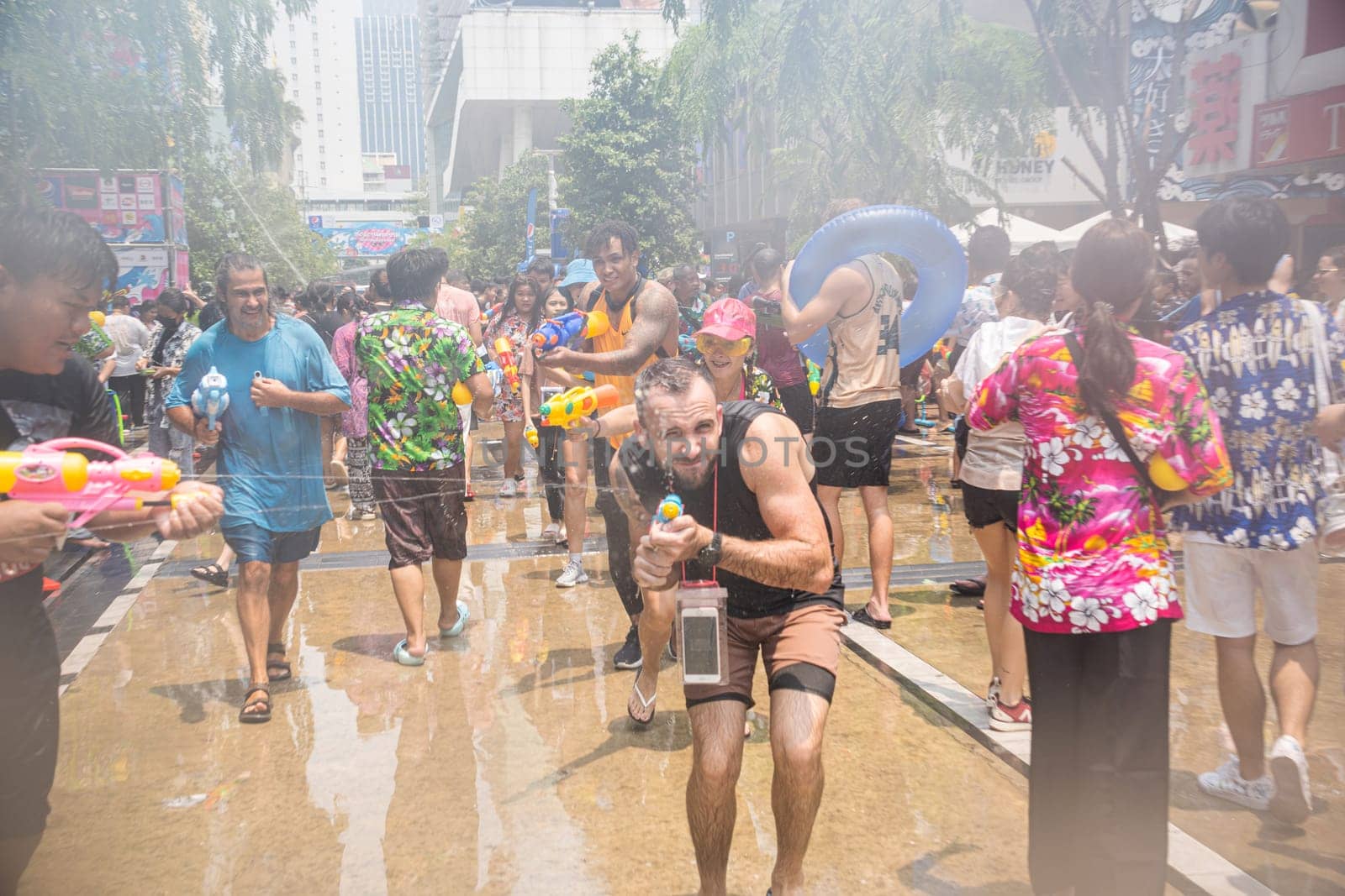 Siam Square, Bangkok, Thailand - APR 13, 2023 Songkran Festival, The short action of people joins celebrations of the Thai New Year or Songkran in Siam Square Bangkok, Thailand.