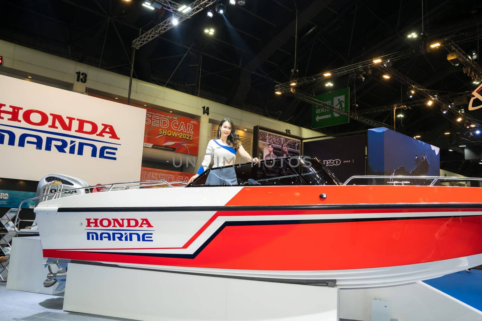 Nonthaburi, Thailand - APR 2, 2023 Unidentified model poses with a boat at The 44th Bangkok international motor show 2023 at IMPACT Arena, Muang Thong Thani, Nonthaburi, Thailand.