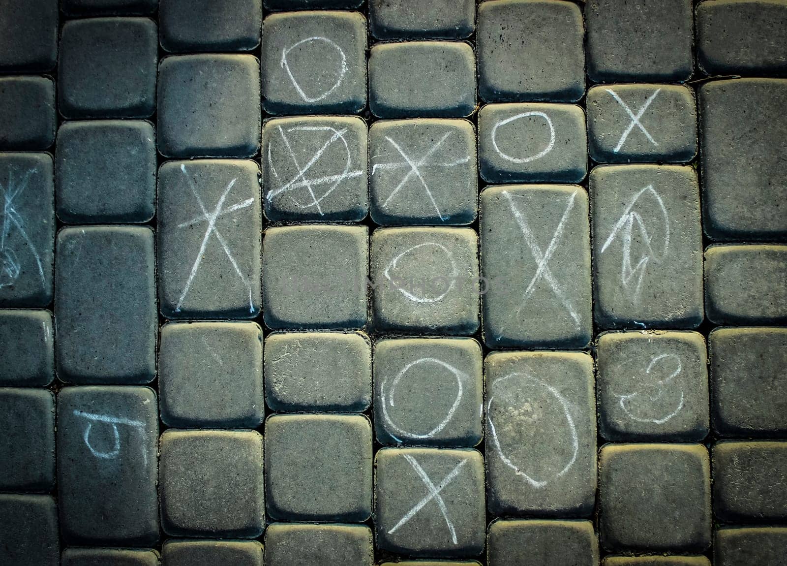 paving tile with pictures of chalk texture. cobblestone sidewalk background. abstract cobblestone background.