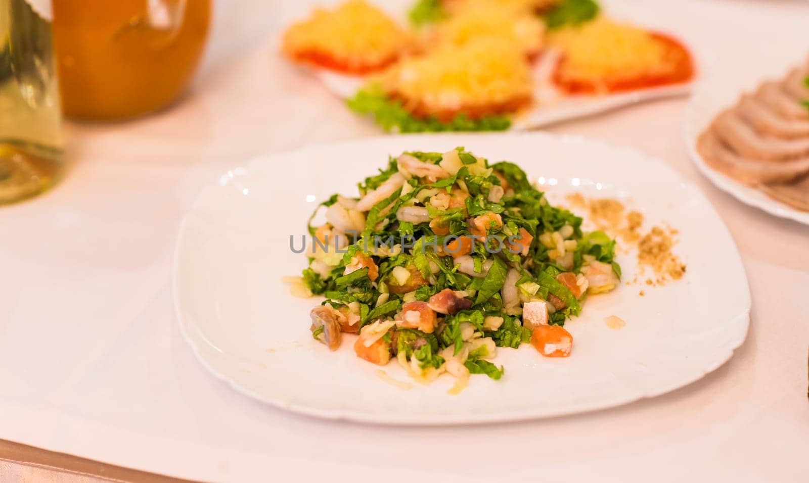 salad with cheese mushrooms and ham on festive table