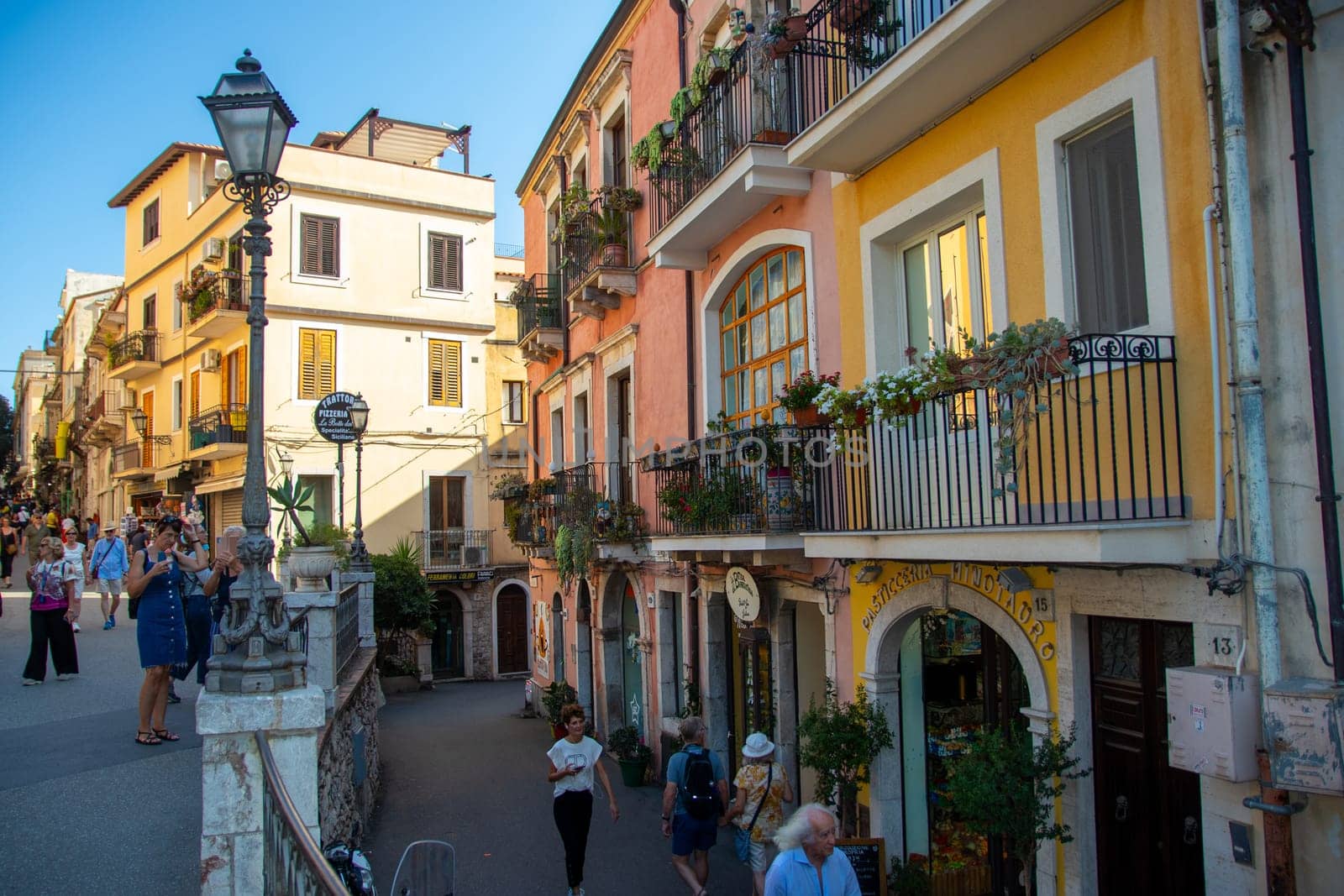Taormina, Sicily, Italy - 28 September 2023. Tourists in the famous main street Corso umberto in Taormina. City views, facades, architecture and the most popular streets.