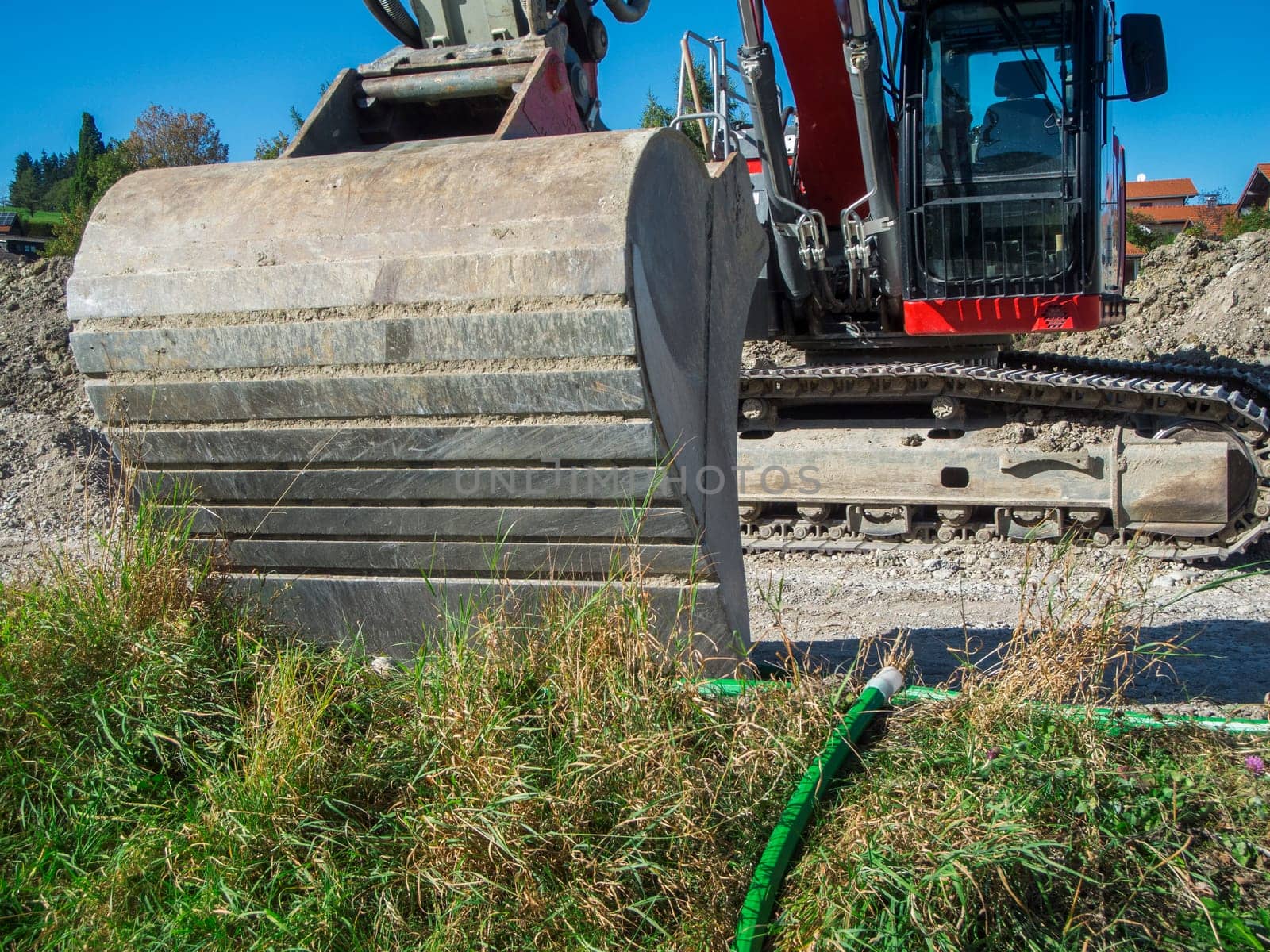 Wide angle view of the outside of a heavy excavator bucket on a construction site in Bavaria in summer.