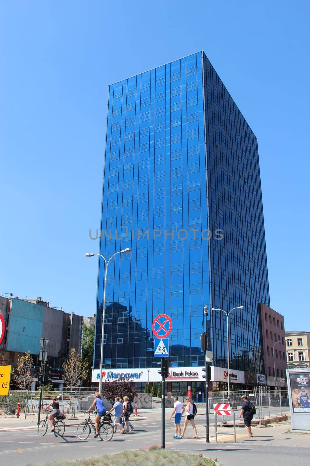 Modern skyscraper standing in Polish city Lodz. City life in Lodz. Busy traffic on streets of Polish city of Lodz. Urban panorama with beautiful architecture