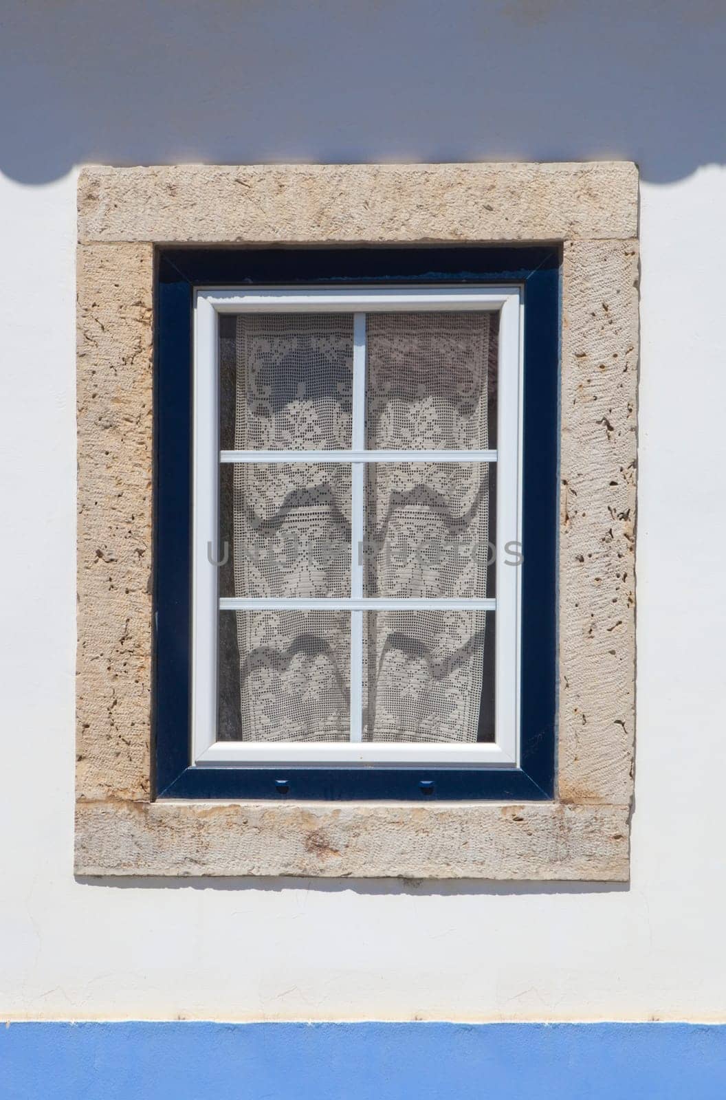 Window painted with vivid colors at Vila Nova de Milfontes house. Little picturesque town on the Alentejo coast, Portugal