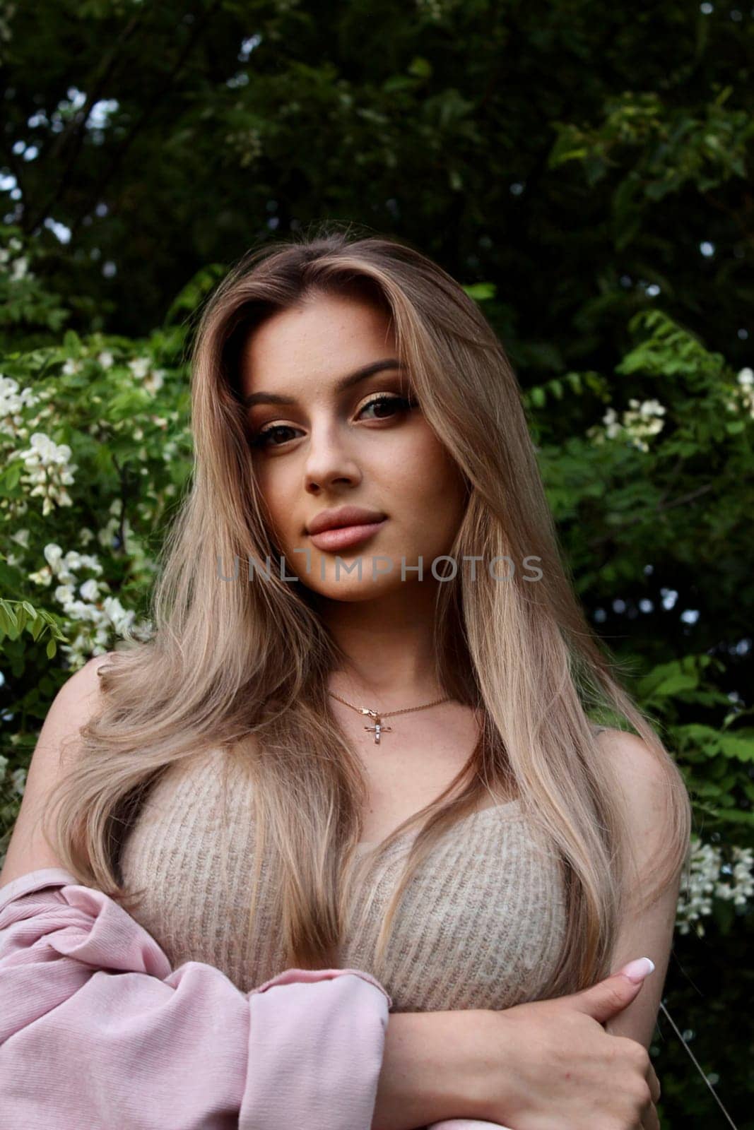 young beautiful woman taking a selfie in a field at sunset