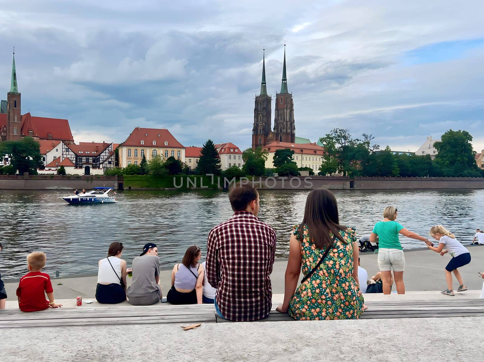 Poland, Wroclaw, July 23, summer 2024. People rest and admire the beautiful view of the Polish city of Wroclaw, fairy-tale houses and the river