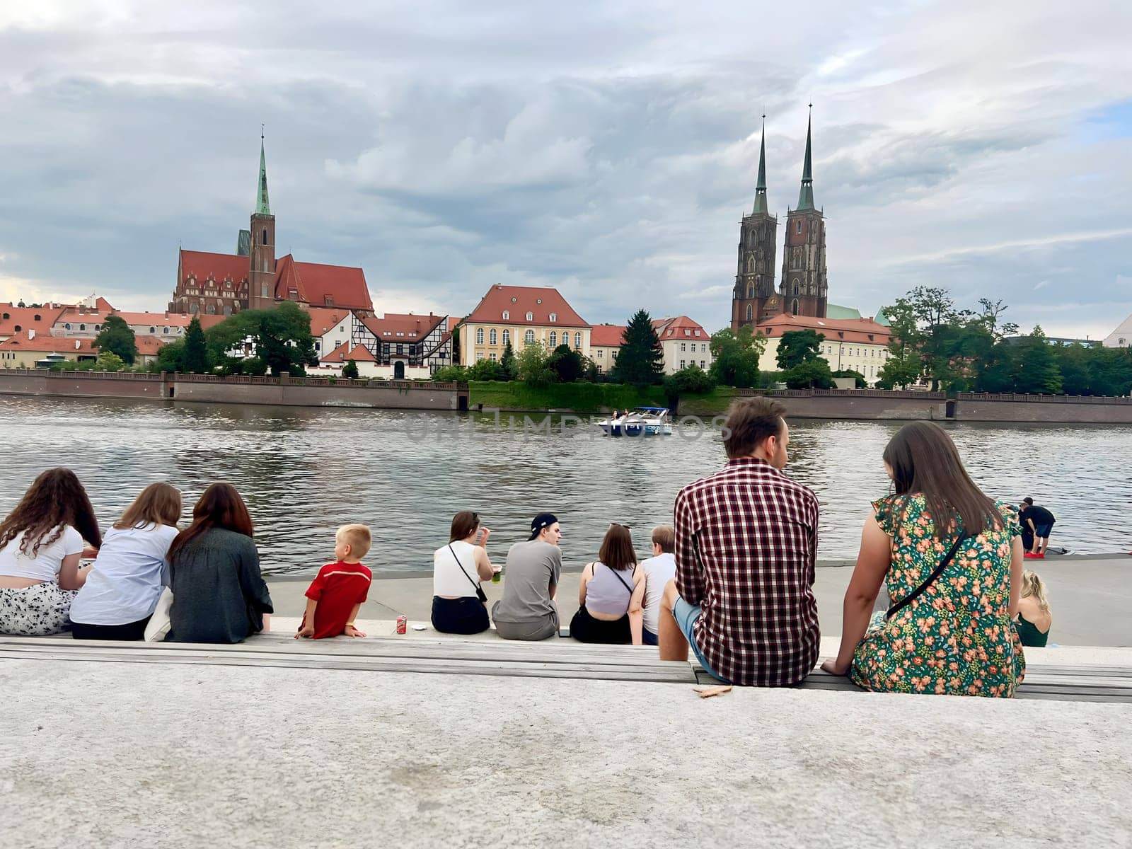 Poland, Wroclaw, July 23, summer 2024. People rest and admire the beautiful view of the Polish city of Wroclaw, fairy-tale houses and the river