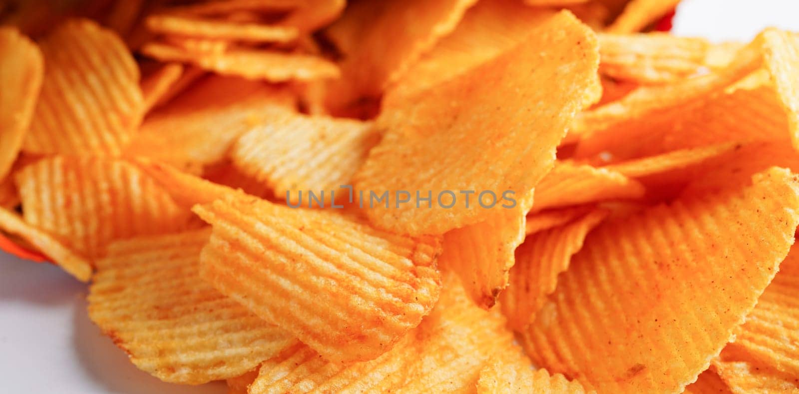 Potato chips in open bag, delicious BBQ seasoning spicy for crips, thin slice deep fried snack fast food.