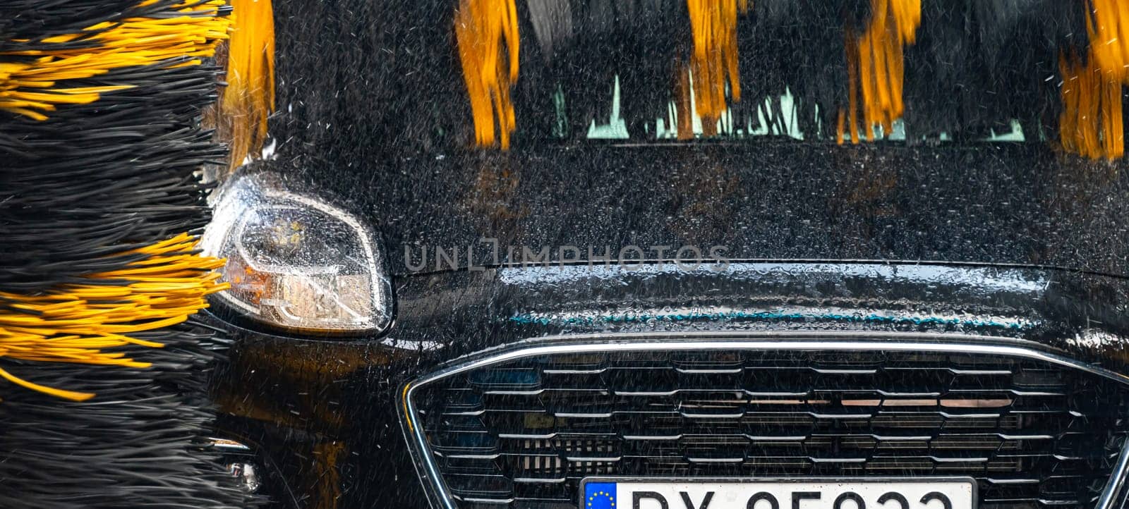 A vehicle in an automatic car wash.