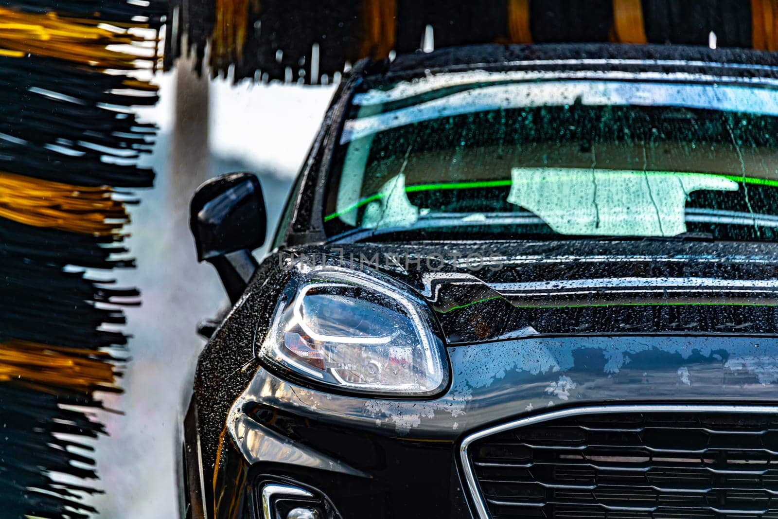 A vehicle in an automatic car wash.
