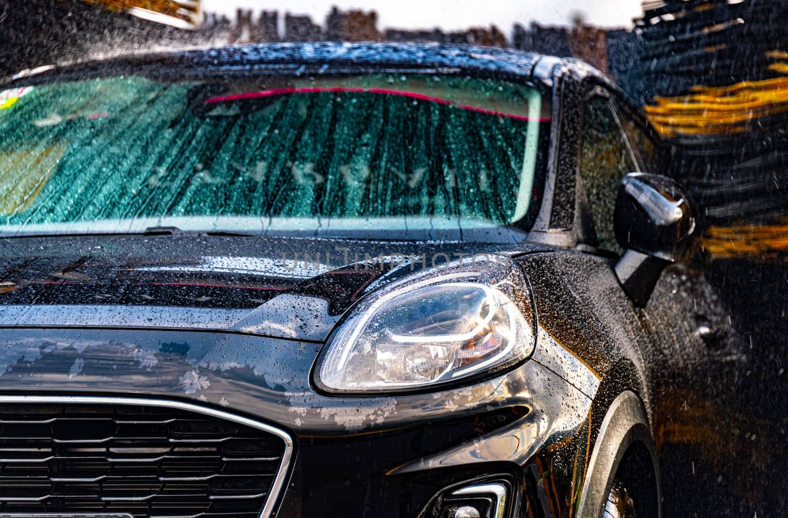 A vehicle in an automatic car wash.