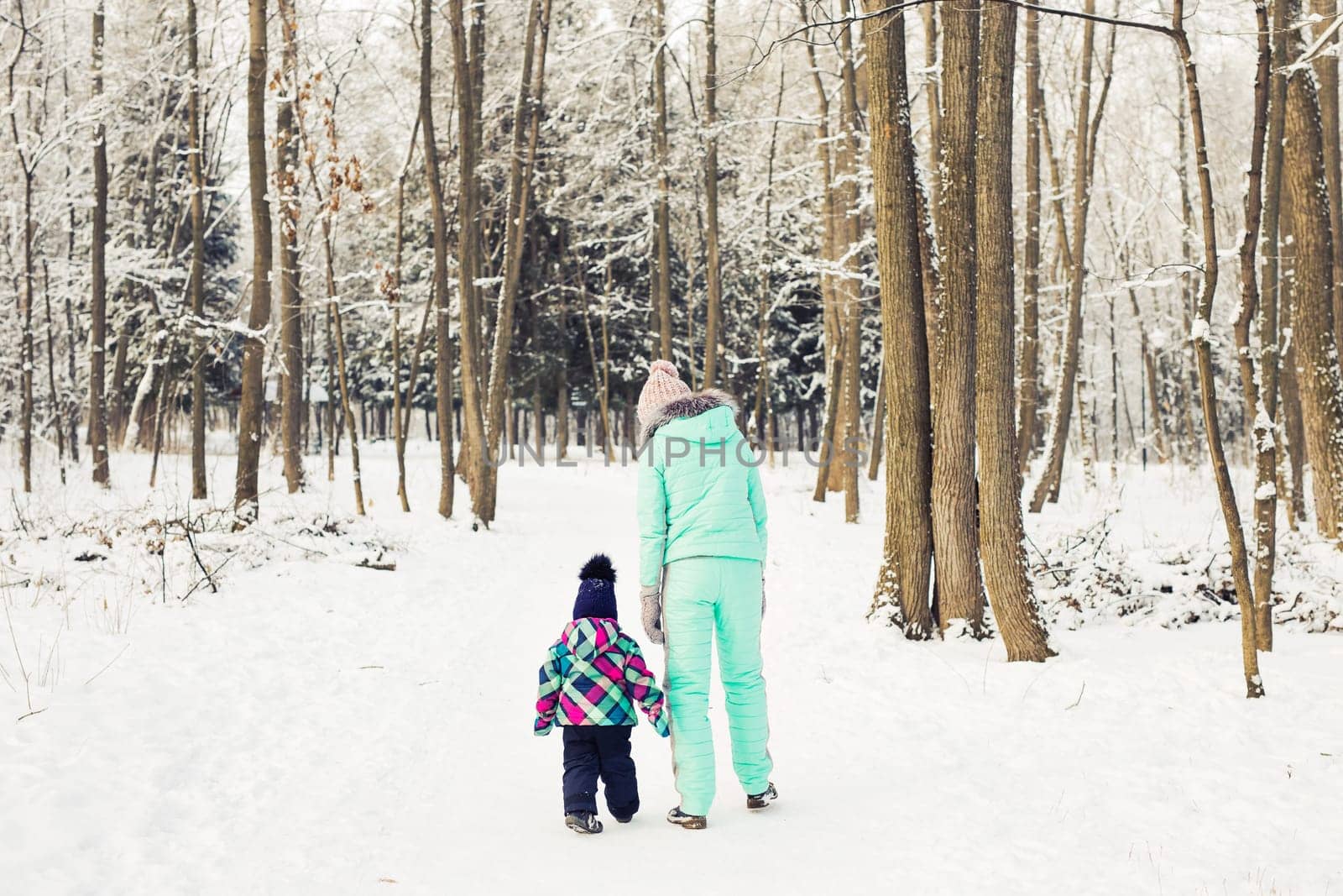 Little girl and her mom having fun on a winter day.