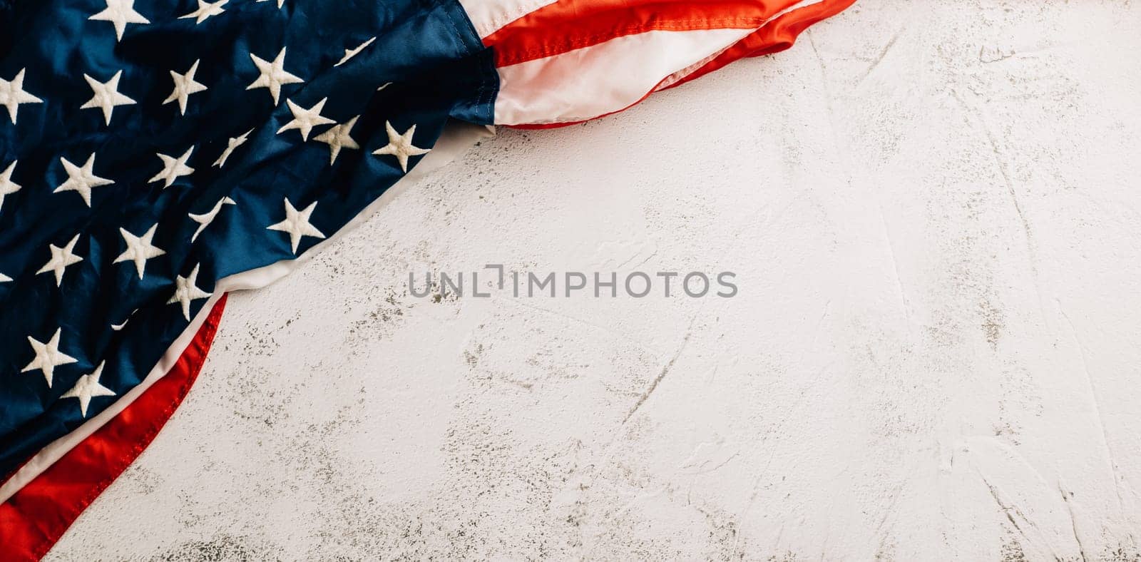 Celebrate Veteran's Day with a vintage US flag, a powerful symbol of American honor, pride, and unity. Patriotic stars and stripes stand for the government. isolated on cement background