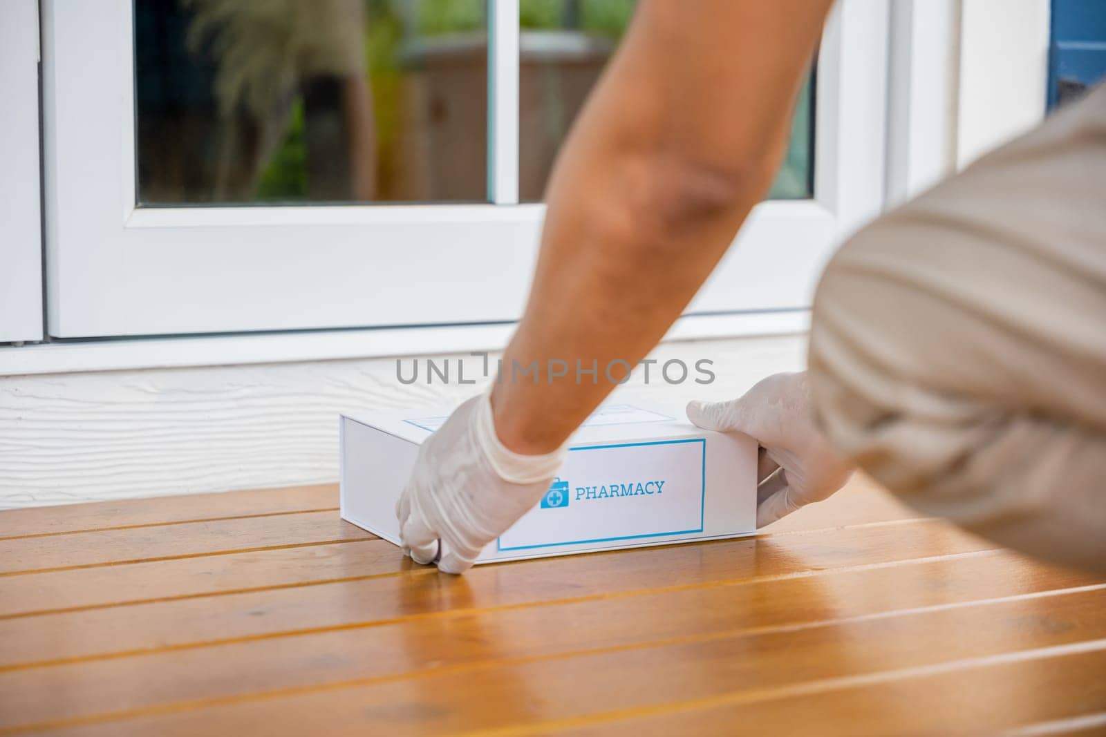 Delivery hands with gloves transport holding give medication box first aid shipment from pharmacy hospital delivery on floor at door front home patient, Buy online clinic retail Rx drug store