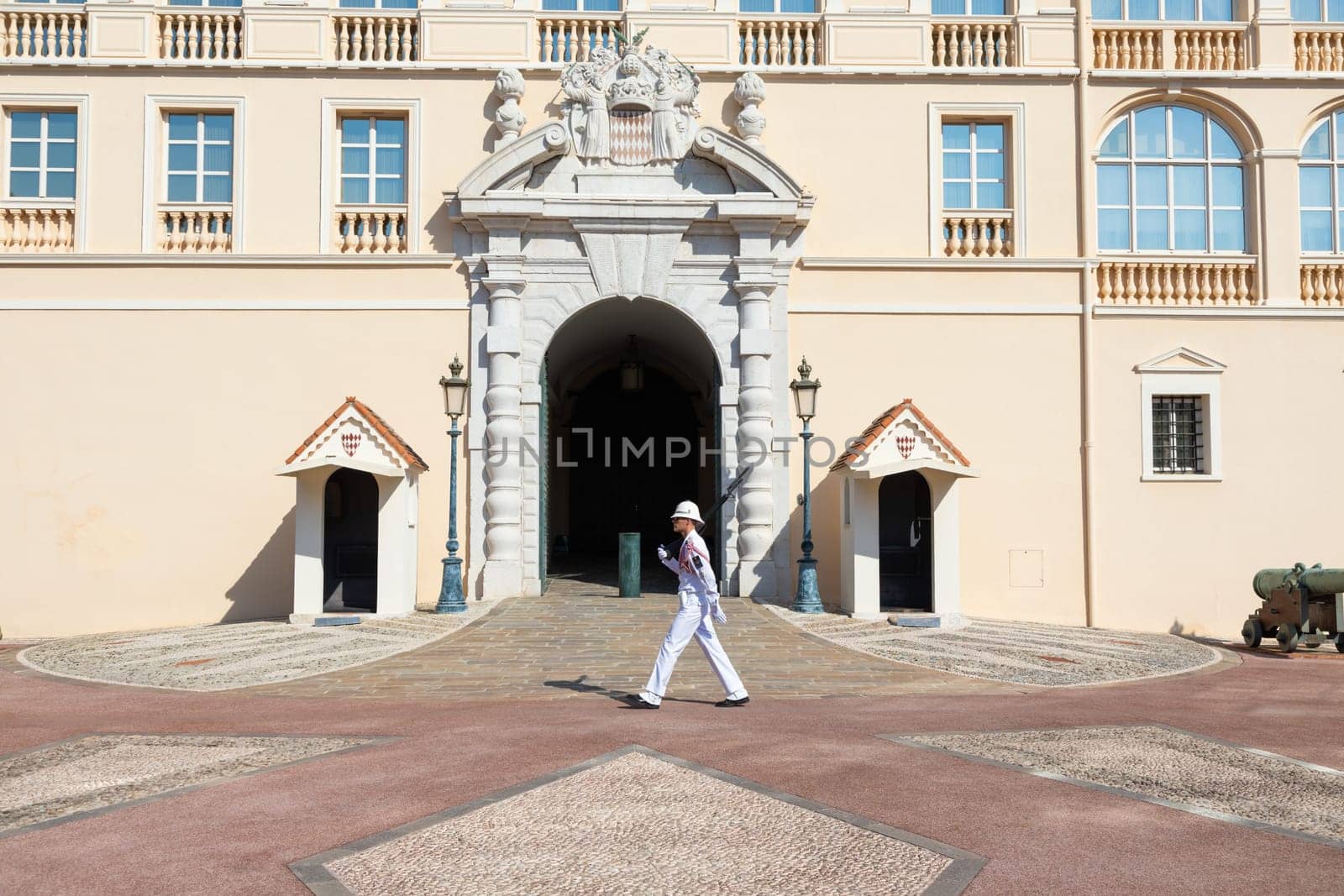 Monte Carlo - August 2022: guard with Summer uniform walking in front of the Royal Palace