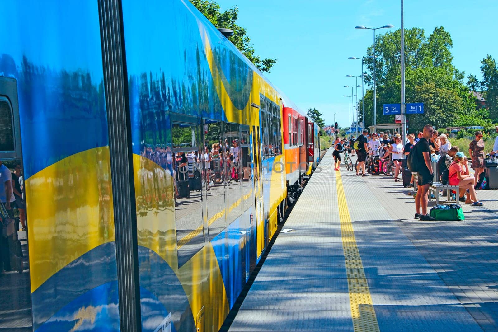 passenger train coming to the railway station. Modern intercity train at the station. Passengers at the railway station. Passengers wait for train on platform. railway transport