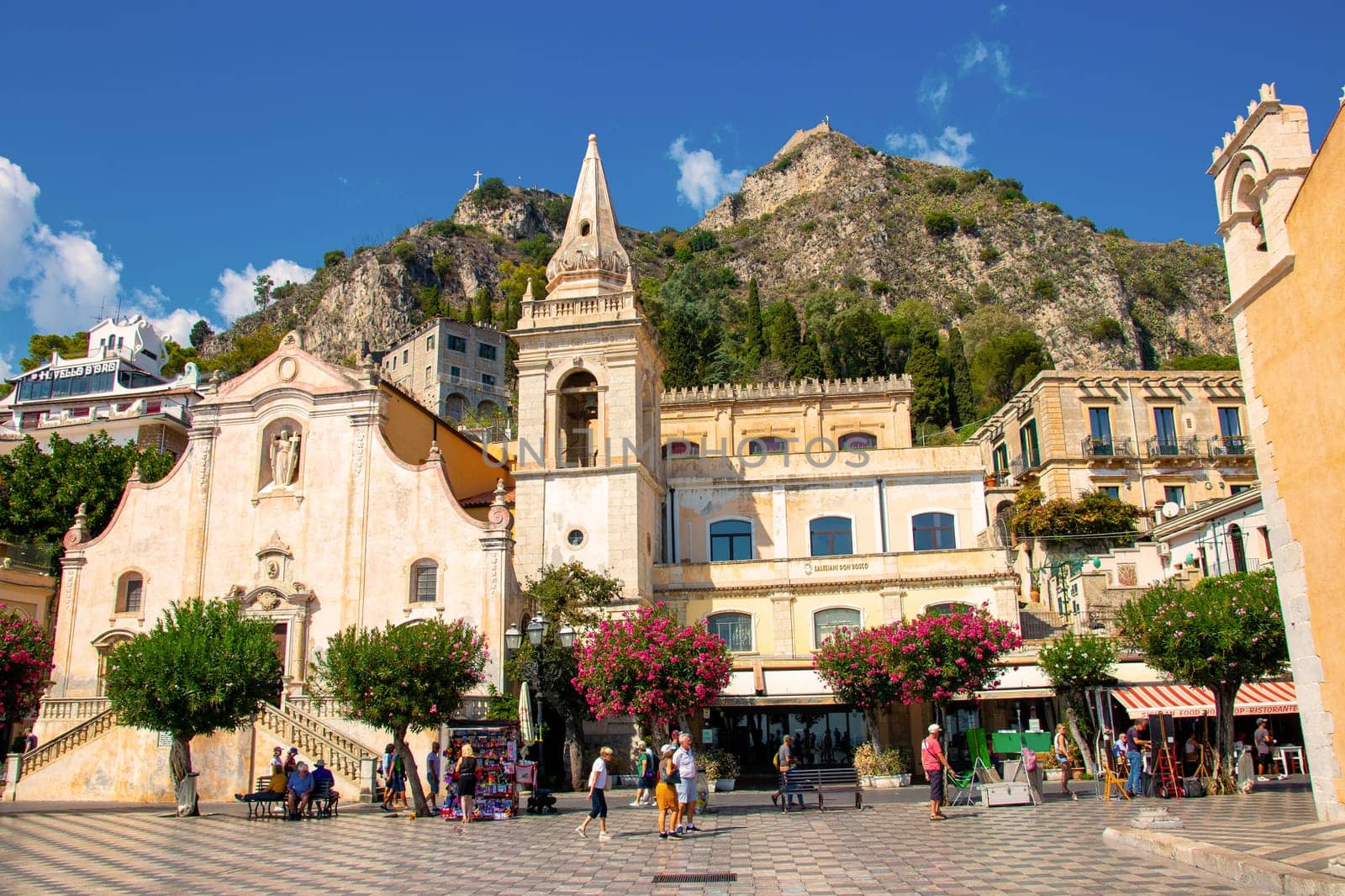 Sicily, Taormina, Italy - 28 September 2023. City views, facades, architecture and the most popular streets. Tourists at Mainsquare Piazza IX Aprile and San Giuseppe church.
