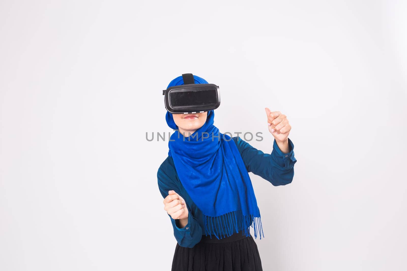 Muslim woman using VR headset. technology, vr, people and game concept.