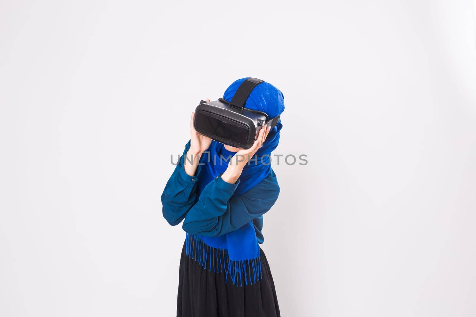 Muslim woman using VR headset. technology, vr, people and game concept.