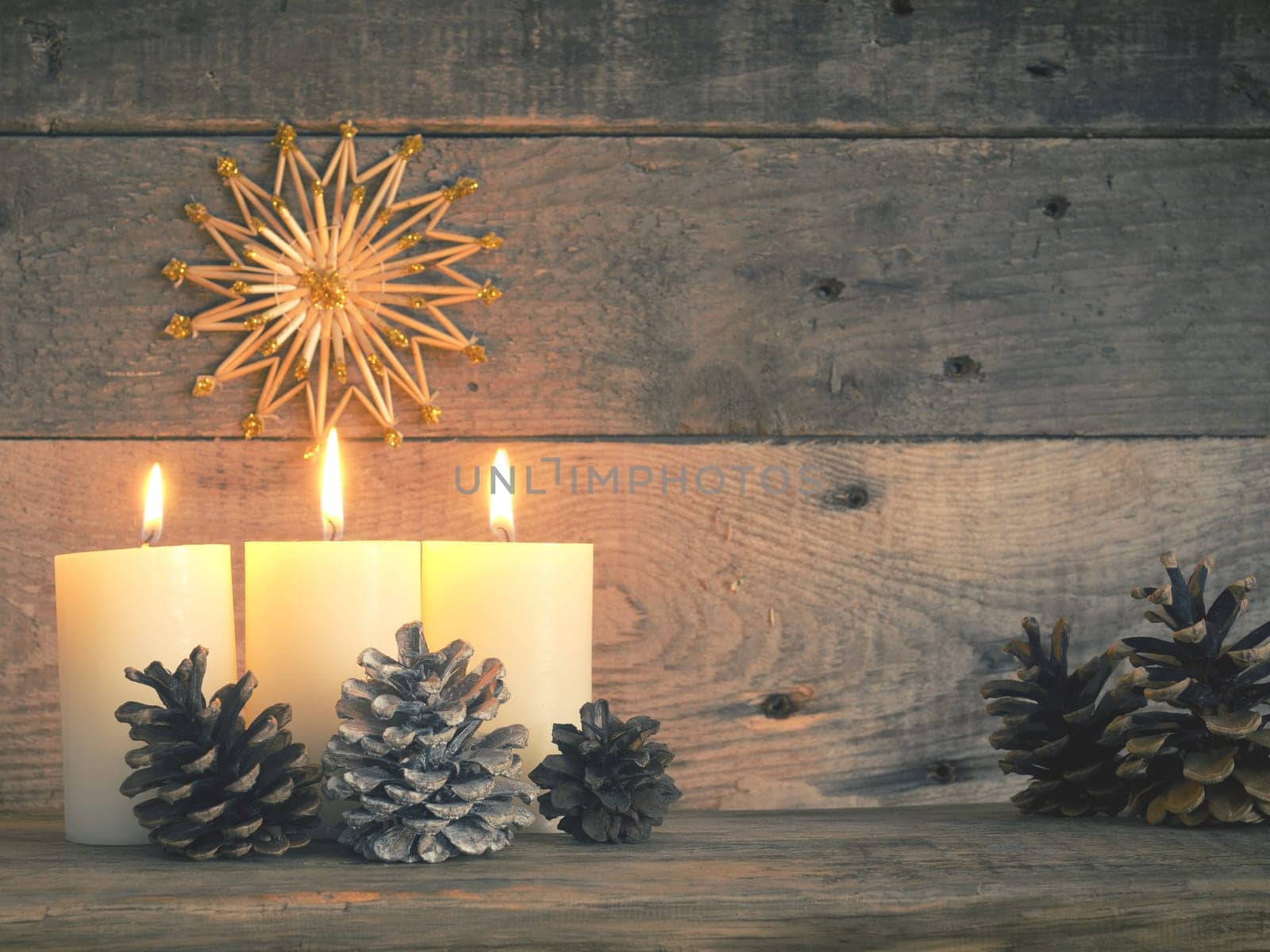 Three Advent candles are burning, third Advent Christmas concept