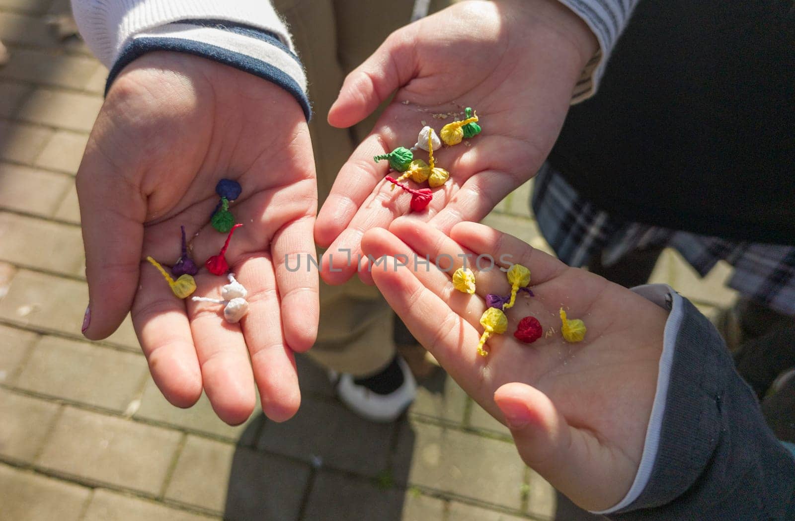 Three children show their hands full of bomblets. Sale of pyrotechnic products at Christmas season