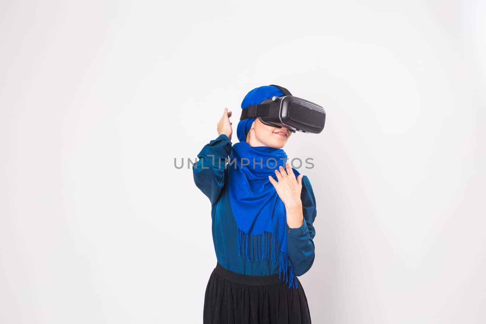 Muslim woman using VR headset. technology, vr, people and game concept.