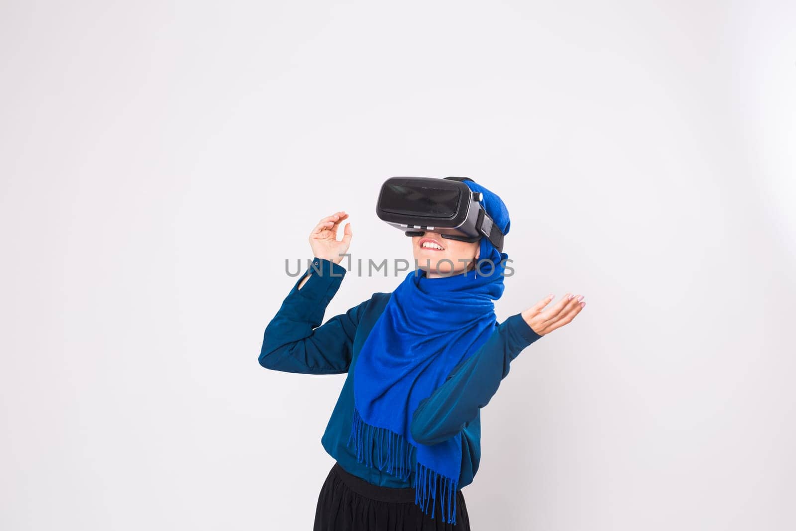 Young muslim woman with virtual reality glasses. Technology, vr, future and people concept.
