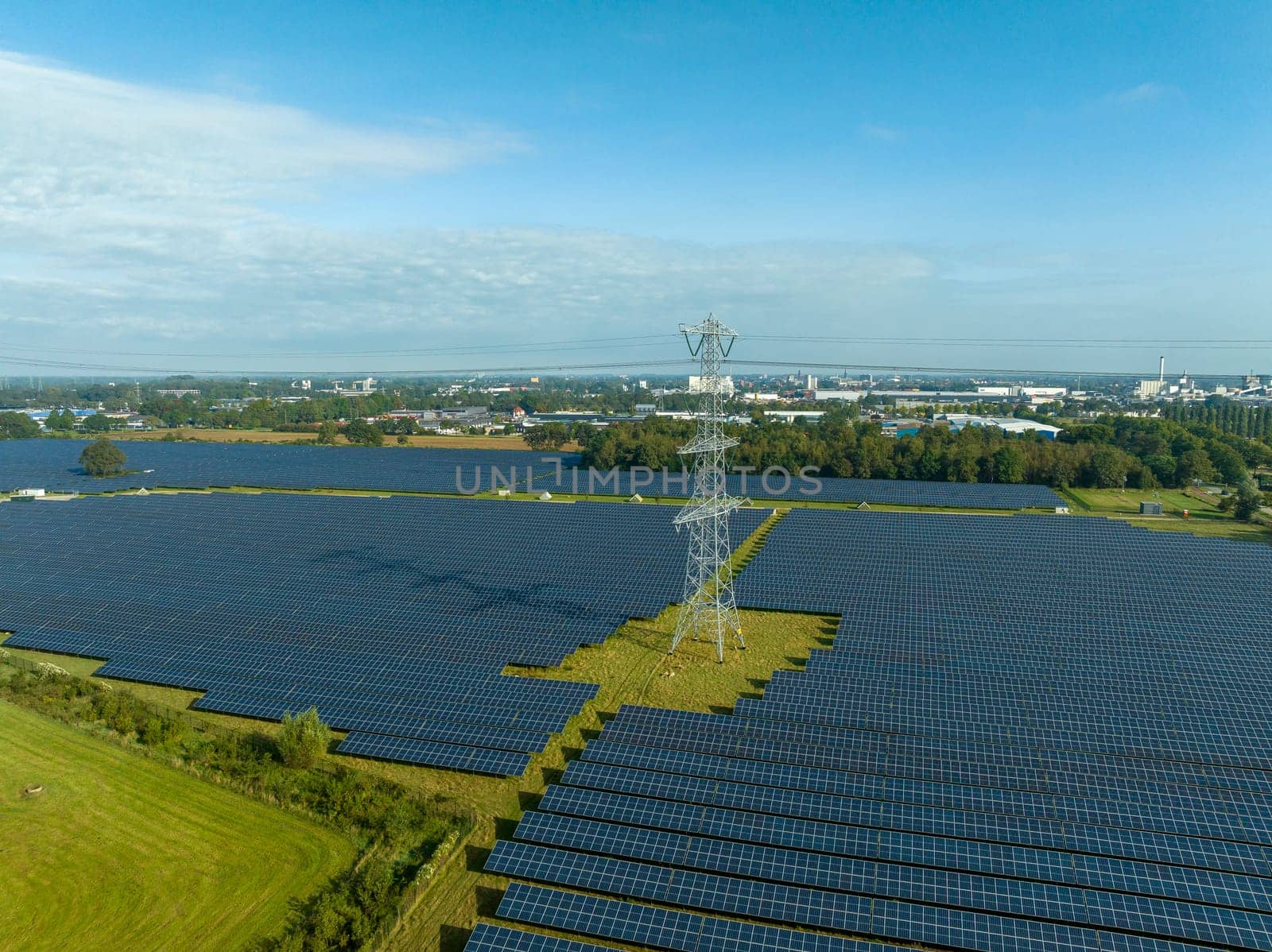 electricity pylons in the middle of a huge solar park