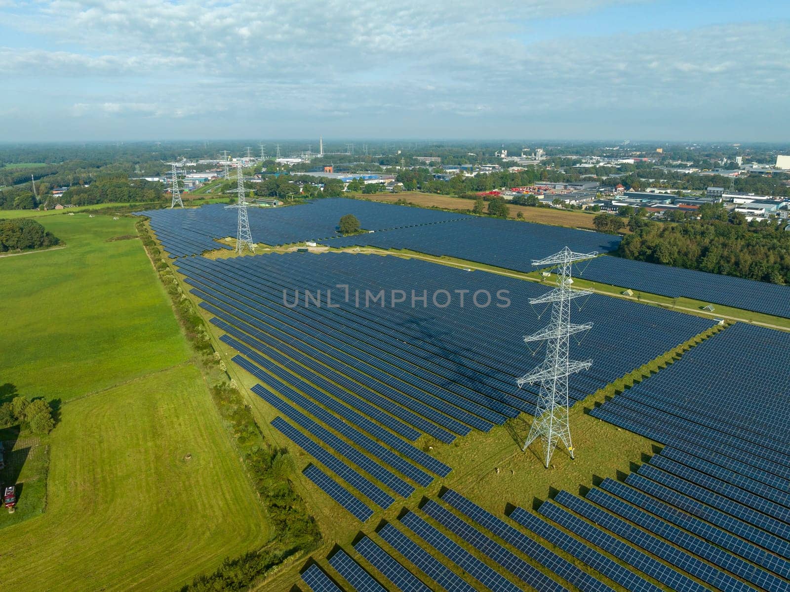 electricity pylons in the middle of a huge solar park