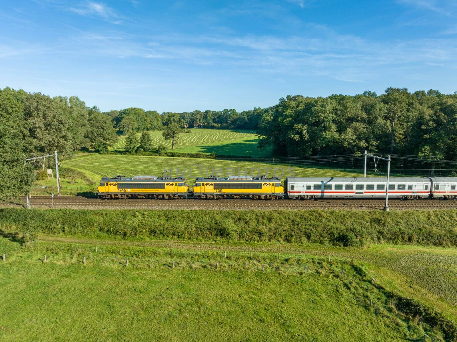 DE LUTTE, NETHERLANDS - SEPTEMBER 15, 2023: German DB passenger train with two dutch railroad (NS) locomotives in front